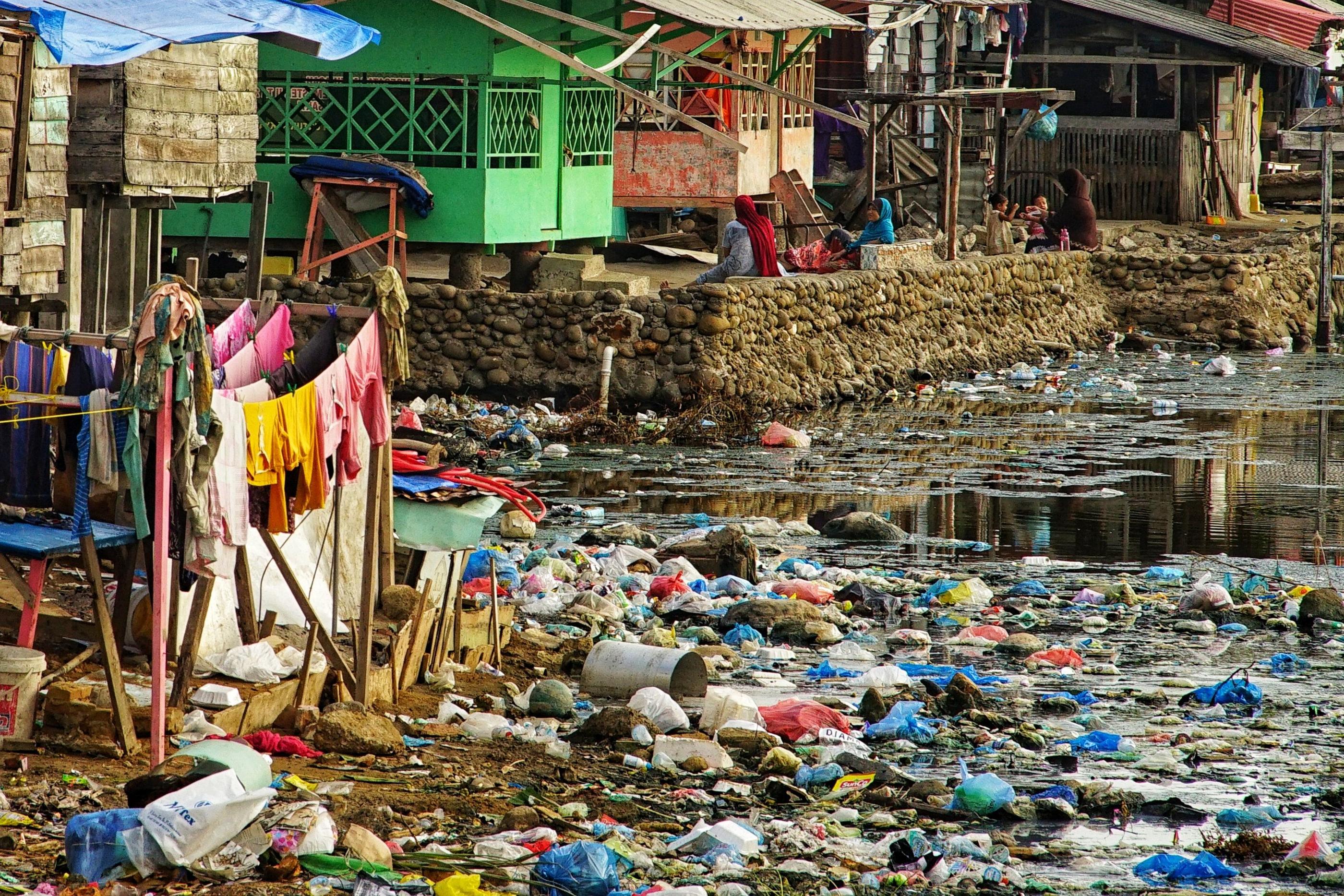 (FILES) This picture shows rubbish washed ashore next to homes beside a river mouth at a coastal village in Lhokseumawe, Indonesia's Aceh province on June 3, 2021. Negotiations on a global treaty to combat plastic pollution will resume on May 29, 2023, with nations under pressure to stem the tide of trash amid calls from campaigners to limit industry influence on the talks. Some 175 nations pledged last year to agree by 2024 a binding deal to end the pollution from largely fossil fuel-based plastics that is choking the environment and infiltrating the bodies of humans and animals. The May 29-June 2 talks in Paris are tasked with agreeing the first outline for actions that could form the basis of a draft negotiating text. (Photo by Azwar Ipank / AFP) / TO GO WITH Pakistan-environment-plastic,FEATURE by Joris Fioriti