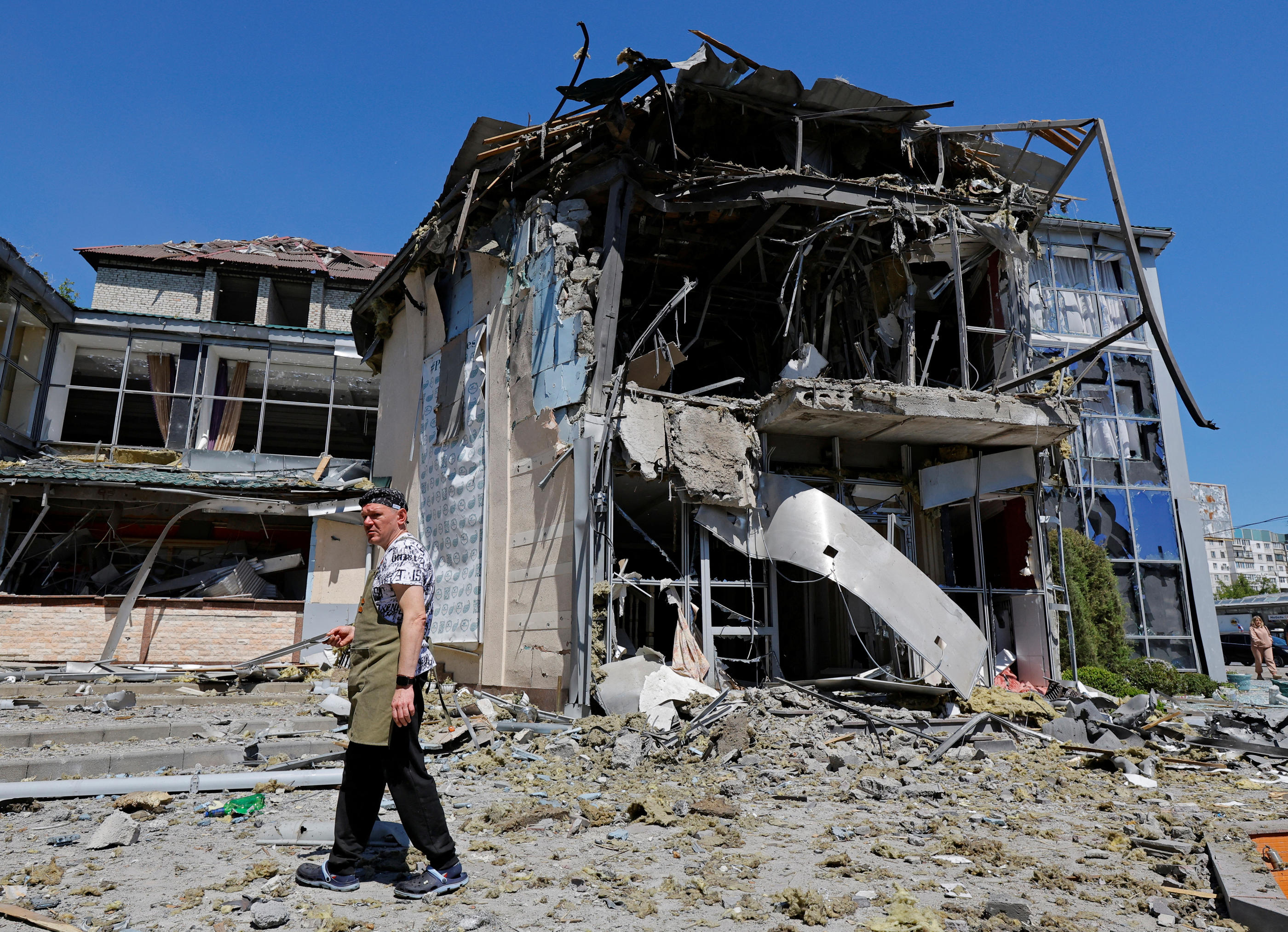 Un employé se tient à l'extérieur d'un restaurant touché par un récent bombardement, que la Russie a qualifié d'attaque militaire ukrainienne. Reuters/Alexander Ermochenko
