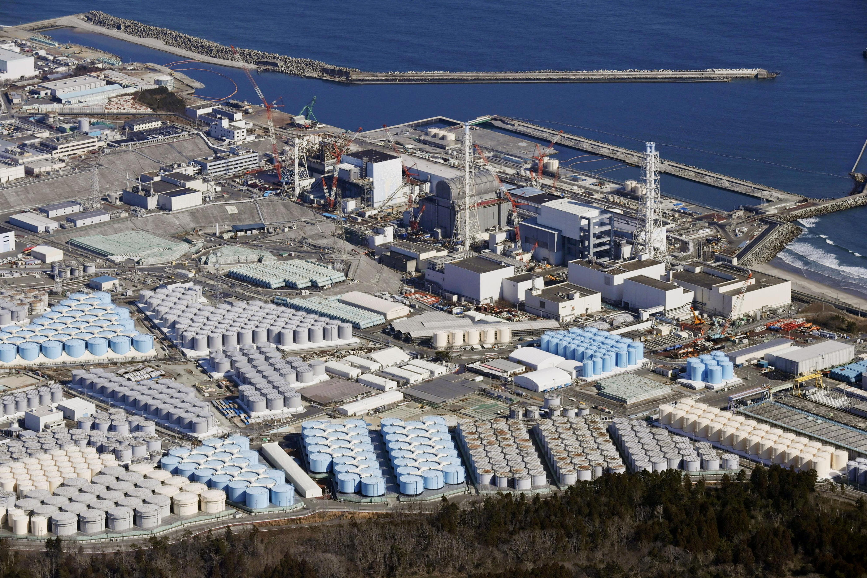 Cette vue aérienne prise en février 2021 montre les réservoirs de stockage d'eau traitée de la centrale nucléaire de Fukushima, au Japon, aujourd'hui remplis à 97% de leur capacité. Reuters/KYODO