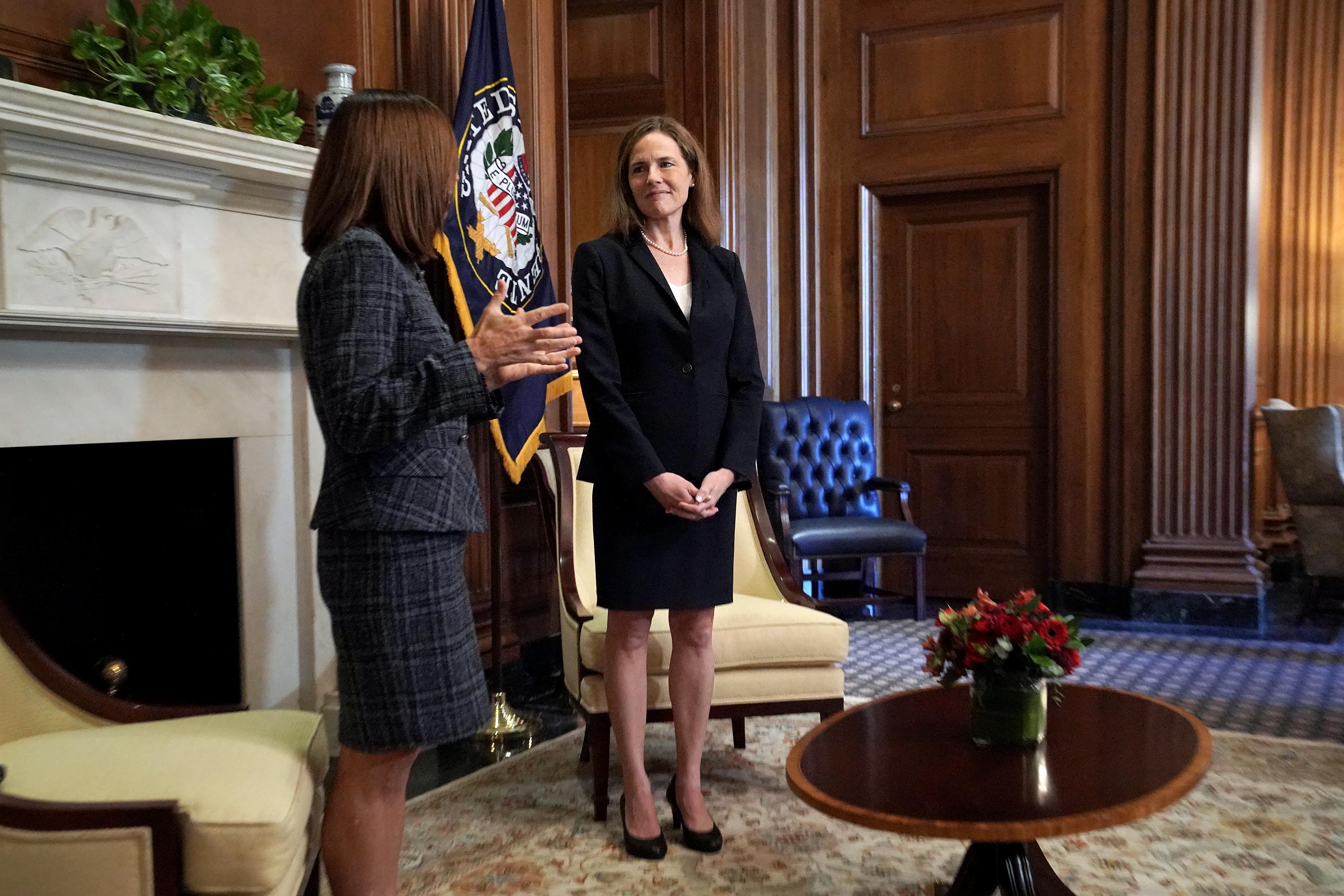 Supreme Court nominee Amy Coney Barrett, right, meets with Sen. Martha McSally, R-Ariz., Wednesday, Oct. 21, 2020, on Capitol Hill in Washington. (Greg Nash/Pool via AP)