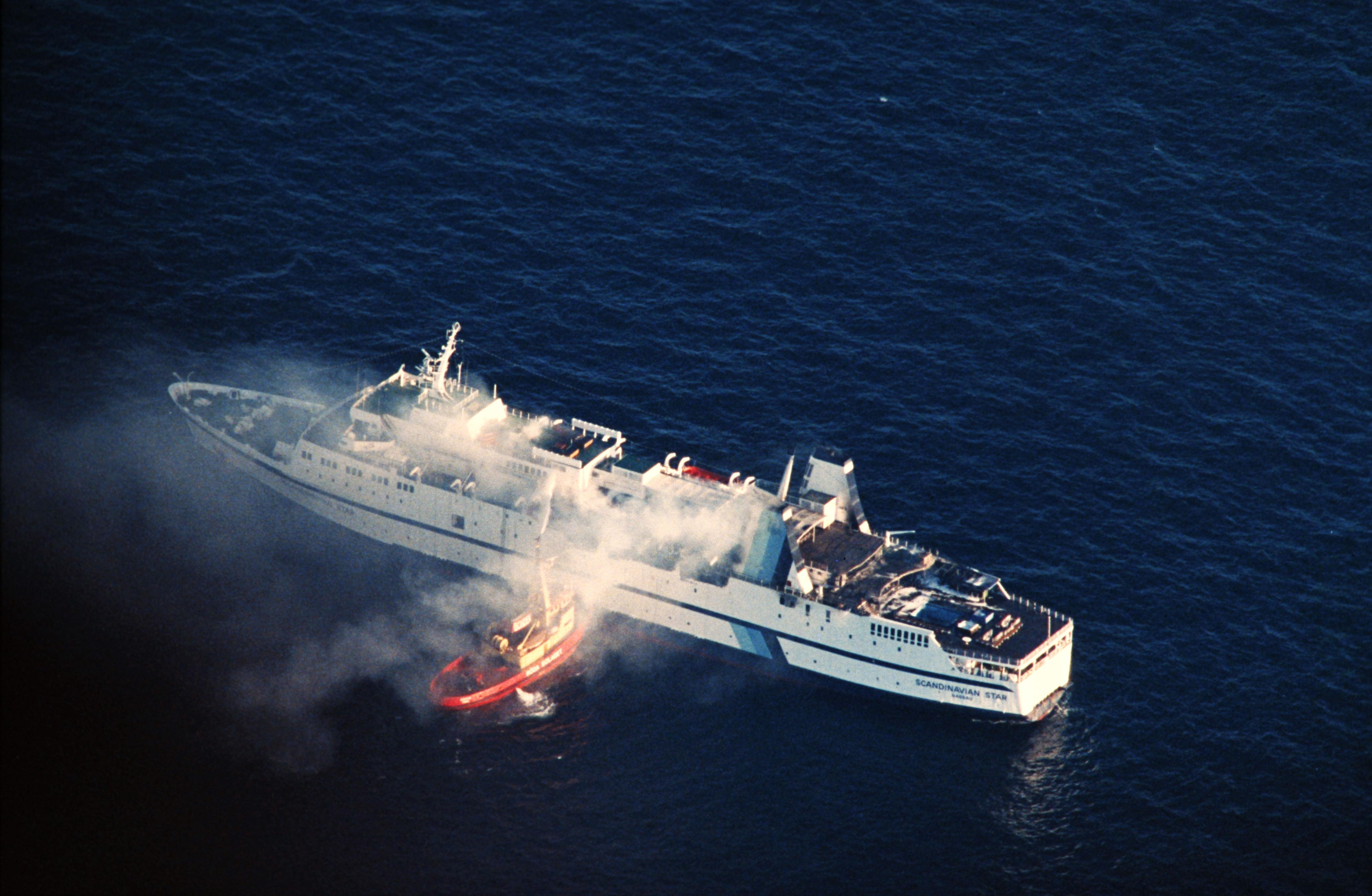 In this picture taken on April 8, 1990 clouds of smoke pour from the ferry Scandanavian Star as firefighters attempt to douse the blaze in Lysekil a day after it was hit by a fire on the North Sea which killed 159 people. The Scandinavian Star car and passenger ferry caught fire between Oslo, Norway and Frederikshavn, Denmark in the evening of April 7, 1990, killing 159 people.
Foto Per Løchen / NTB