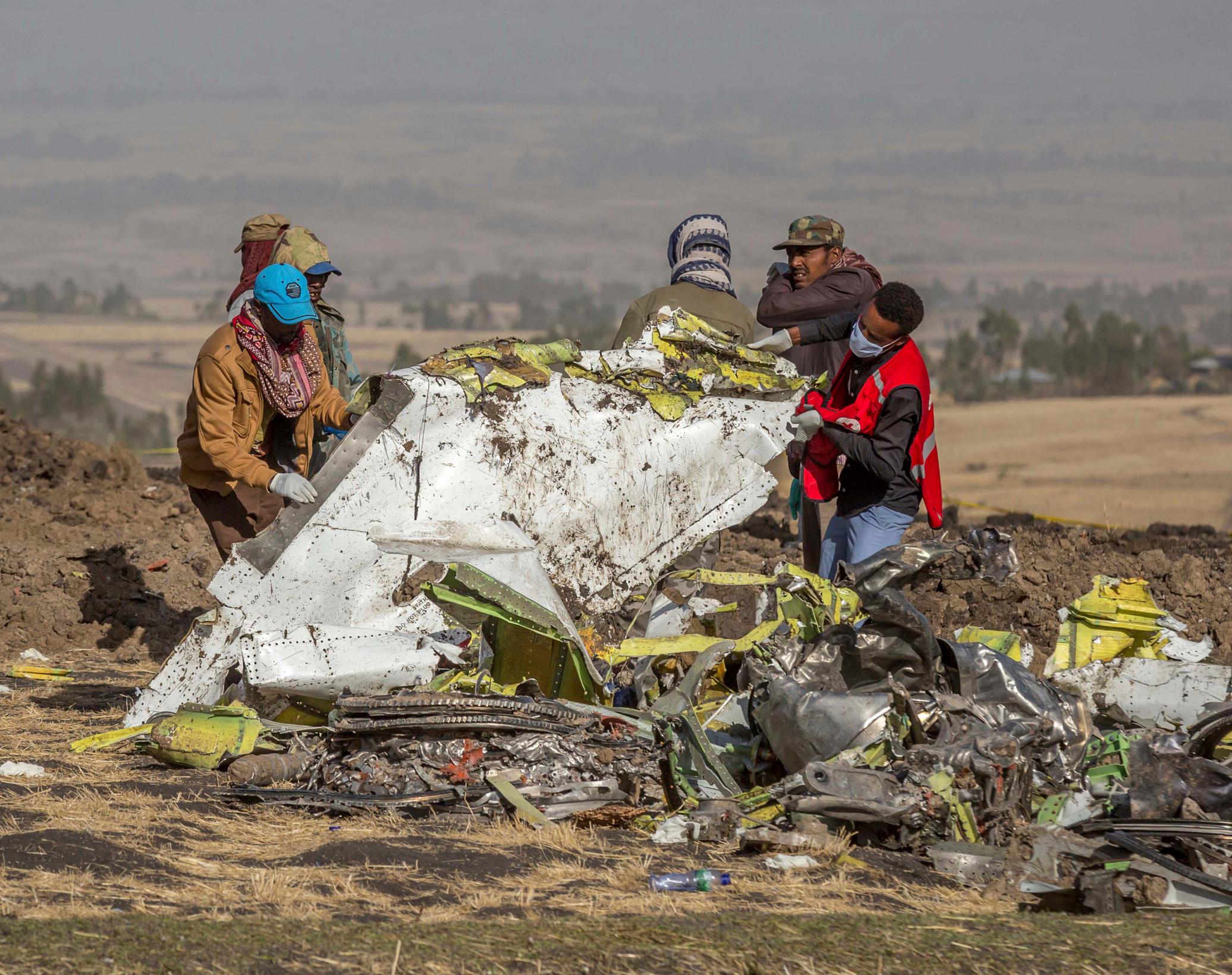 FILE - In this March 11, 2019, file photo, rescuers work at the scene of an Ethiopian Airlines flight crash near Bishoftu, Ethiopia. Pilot Bernd Kai von Hoesslin pleaded with his bosses for more training on the Boeing Max, just weeks before the Ethiopian AirlineÄôs jet crashed, killing everyone on board. (AP Photo/Mulugeta Ayene, File)