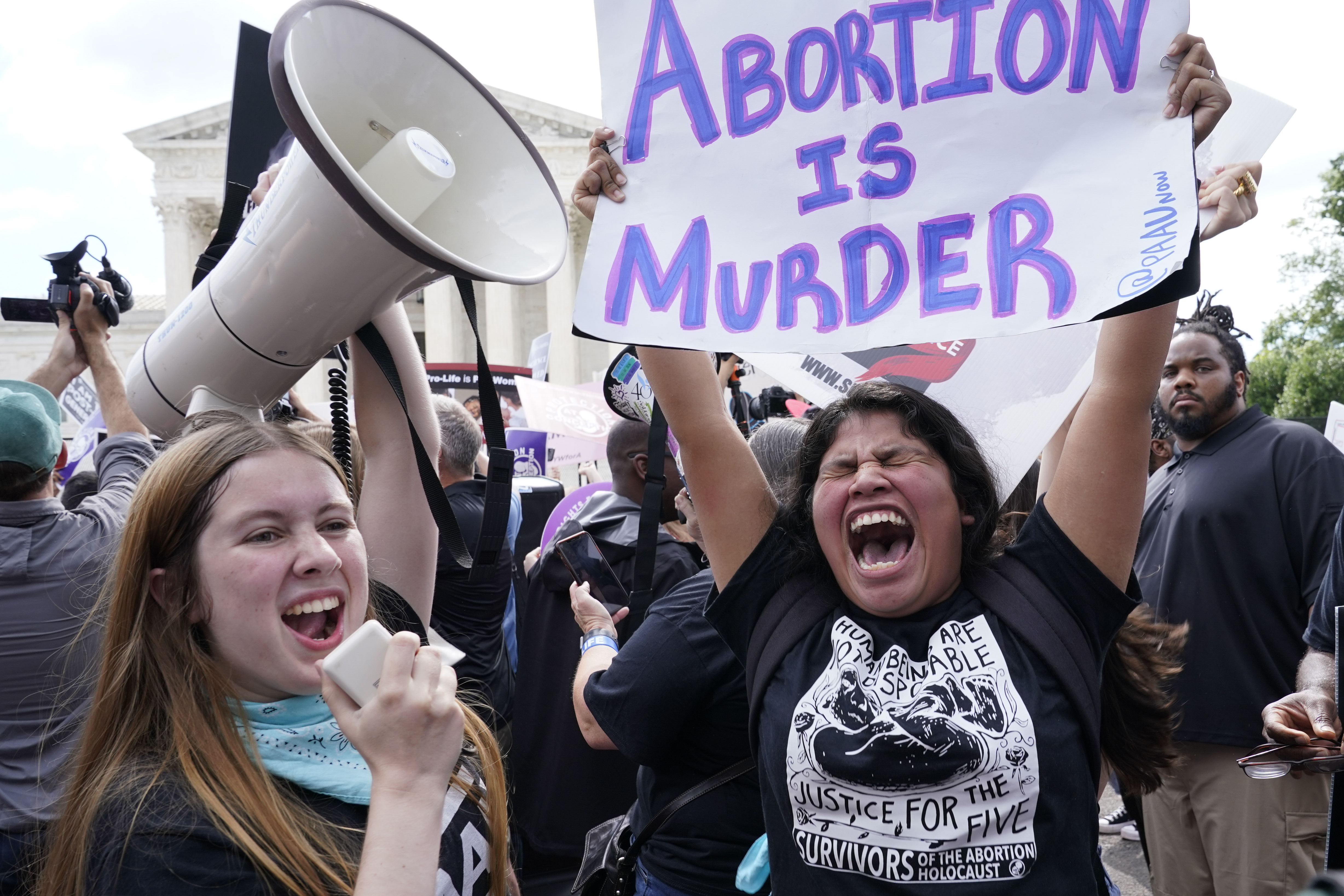 People celebrate outside the Supreme Court, Friday, June 24, 2022, in Washington. The Supreme Court has ended constitutional protections for abortion that had been in place nearly 50 years, a decision by its conservative majority to overturn the court's landmark abortion cases. (AP Photo/Jacquelyn Martin)