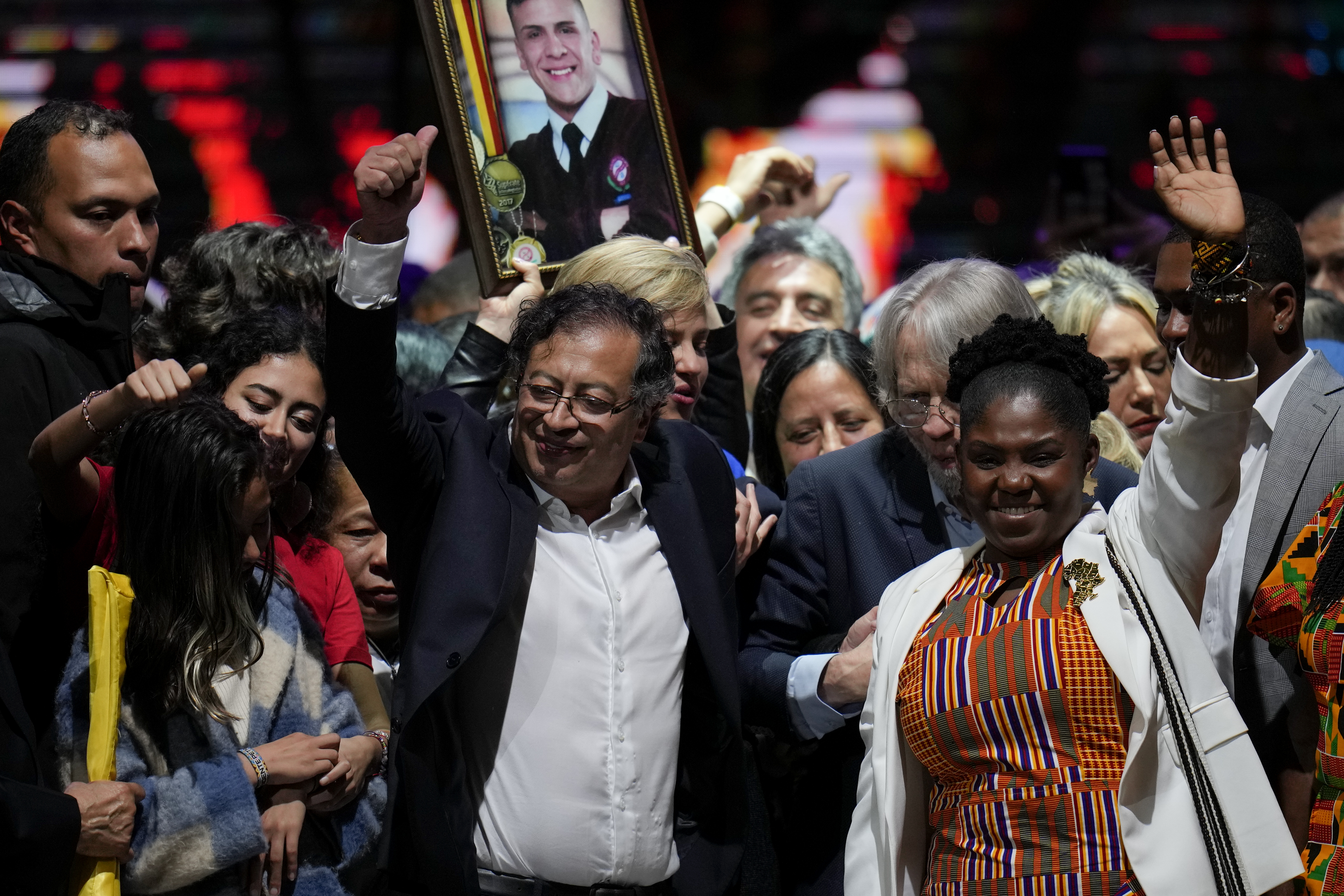 Former rebel Gustavo Petro and his running mate Francia Marquez, celebrate before supporters after winning a runoff presidential election in Bogota, Colombia, Sunday, June 19, 2022. (AP Photo/Fernando Vergara)