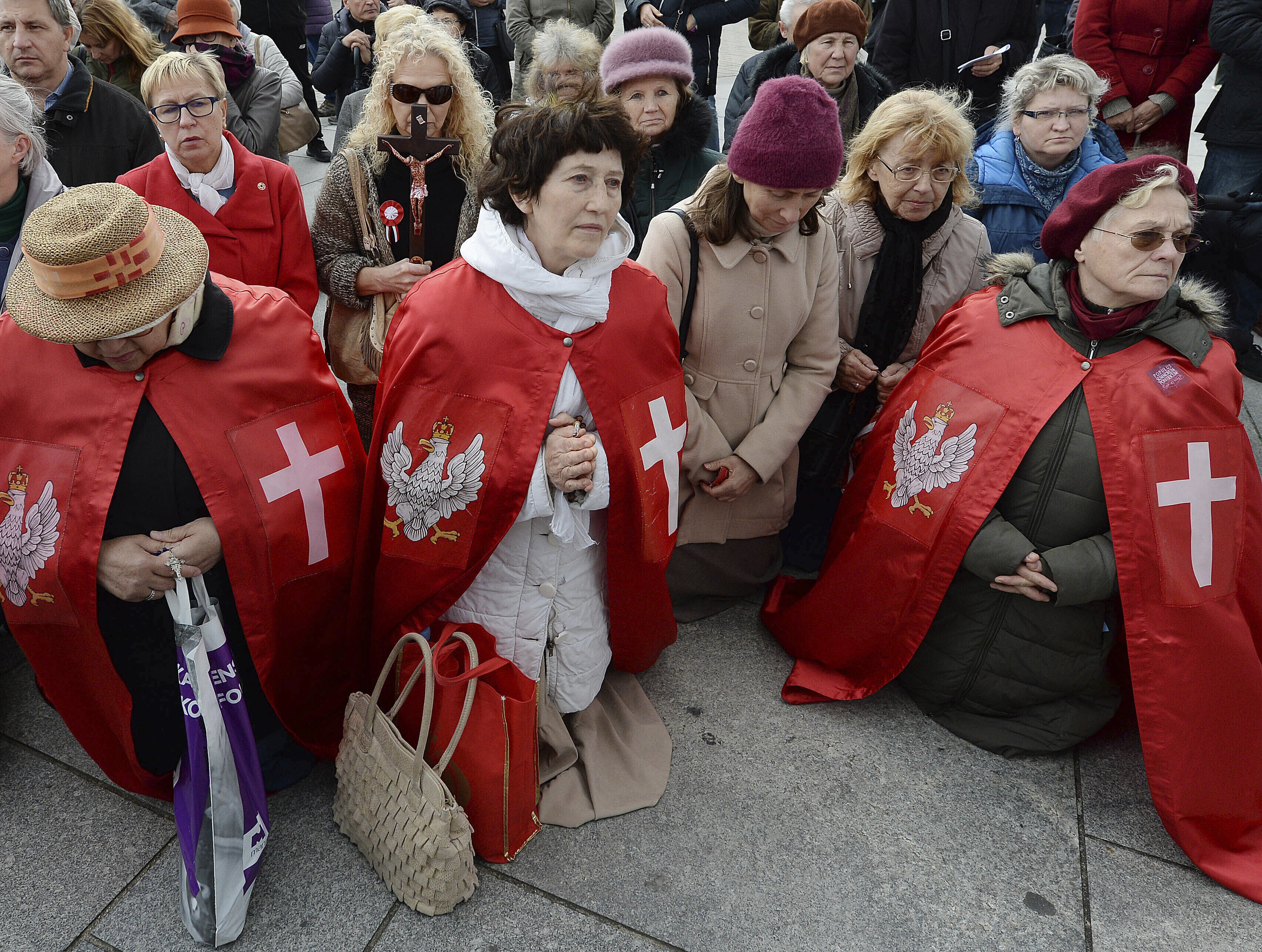 In this Oct. 5, 2019, photo, Polish Catholics pray at an anti-gay event in Warsaw, Poland. About 200 people marched holding rosaries and crucifixes and praying to apologize for what they say is the desecration of pride parades. (AP Photo/Czarek Sokolowski)