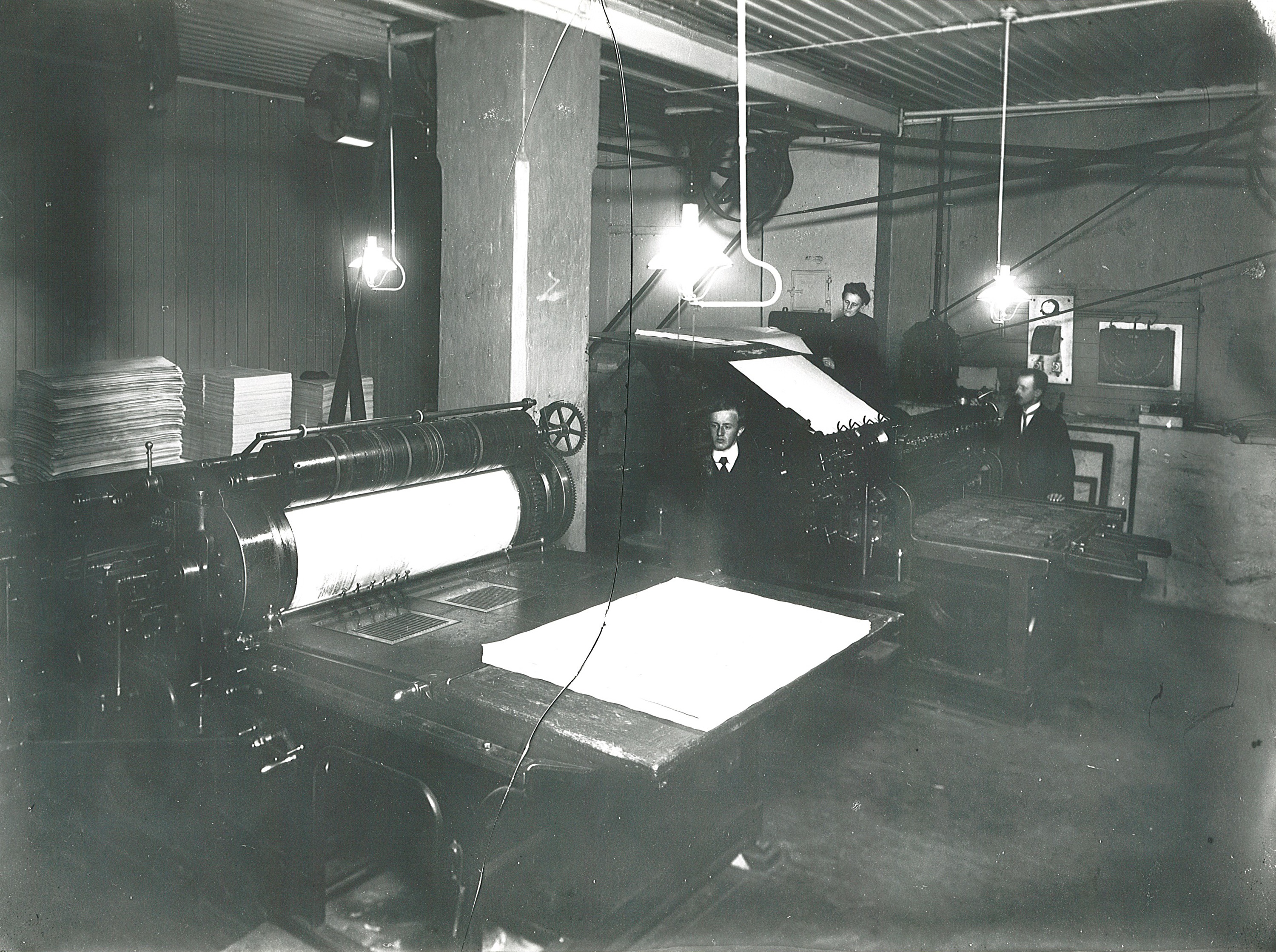 Trykkarka ble ført rundt med sylinderen og pressa mot trykkforma som var innsatt med farge. Her ser vi trykker og påleggerske ved Sundhedsbladets boktrykkeri i Akersgata 74 i 1908.