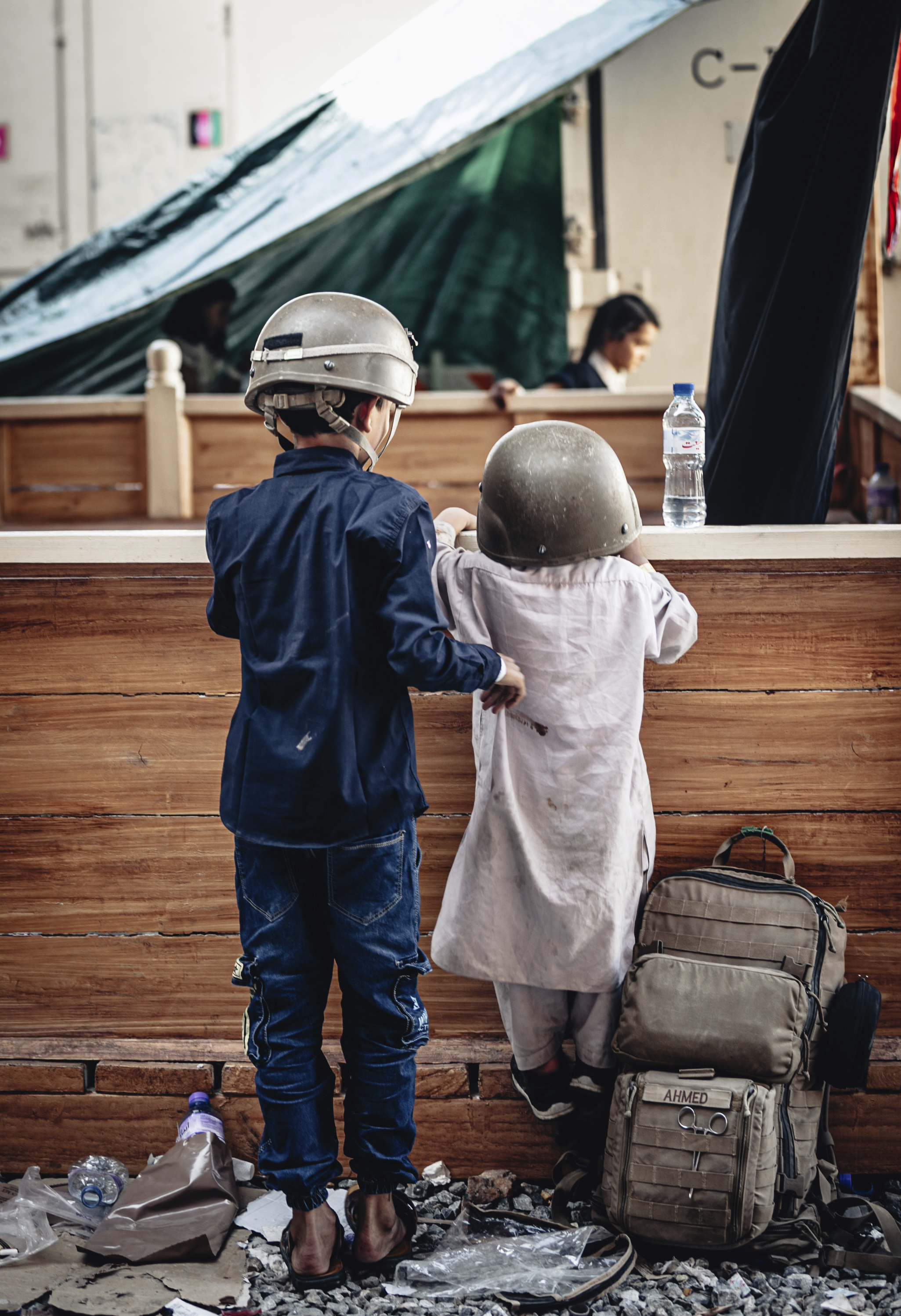 In this image provided by the U.S. Marine Corps, children wait to be evacuated, at Hamid Karzai International Airport, Monday, Aug. 23. (Gunnery Sgt. Melissa Marnell/U.S. Marine Corps via AP)