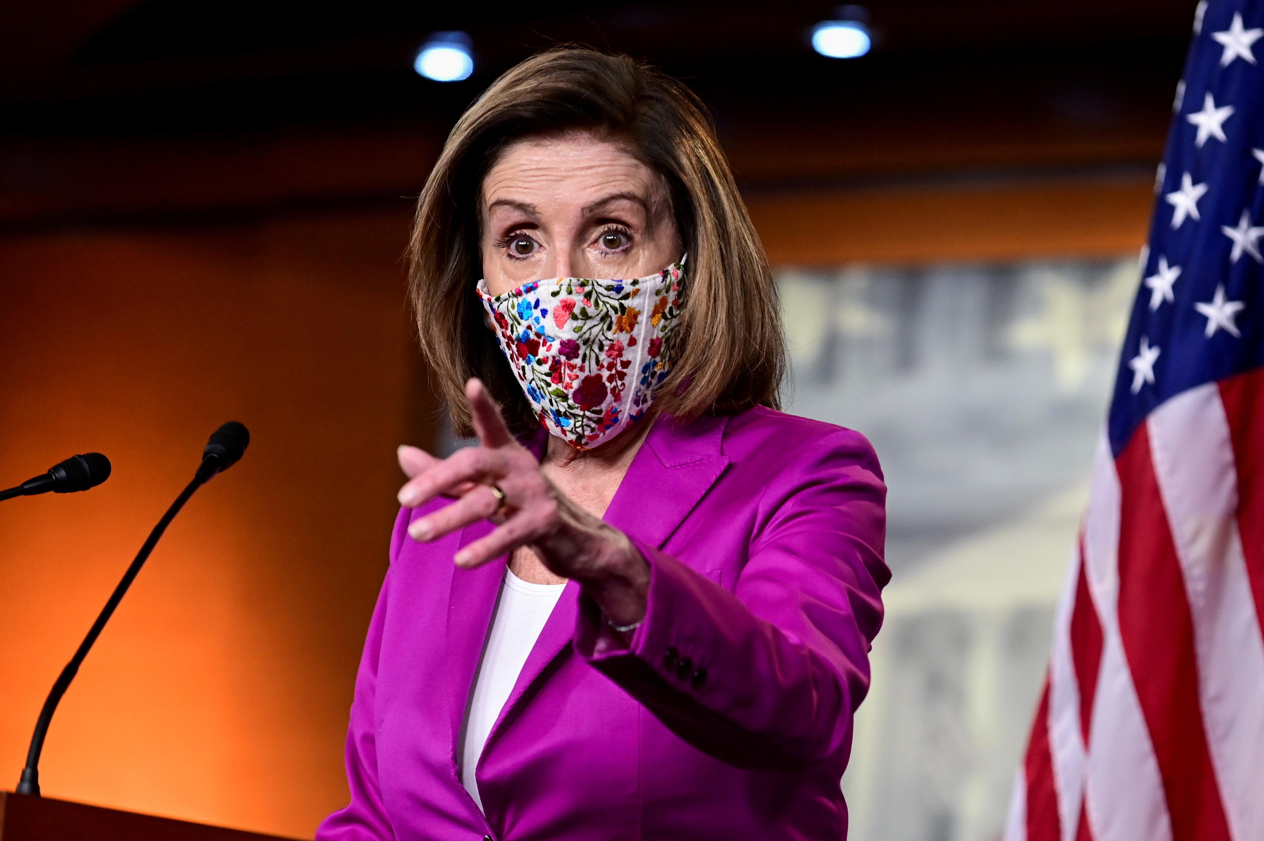 FILE PHOTO: U.S. House Speaker Nancy Pelosi (D-CA) speaks to reporters a day after supporters of U.S. President Donald Trump occupied the Capitol, during a news conference in Washington, U.S., January 7, 2021. REUTERS/Erin Scott/File Photo