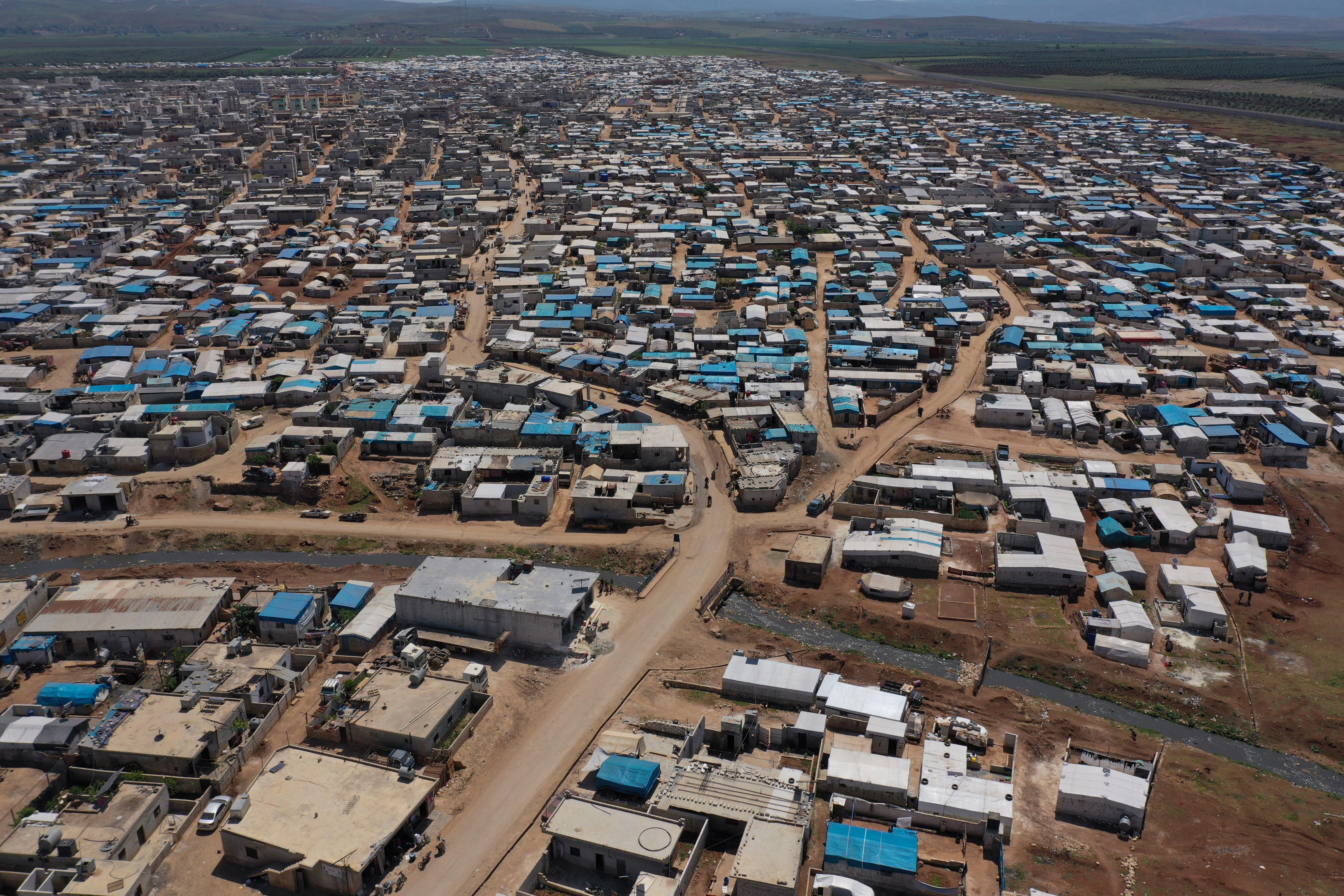 FILE - This April 19, 2020 file photo shows a large refugee camp on the Syrian side of the border with Turkey, near the town of Atma, in Idlib province, Syria. The head of the U.N. food agency warned of starvation and another wave of mass migration from Syria to Europe unless donors countries step up financial assistance to the war-ravaged country. (AP Photo/Ghaith Alsayed, File)