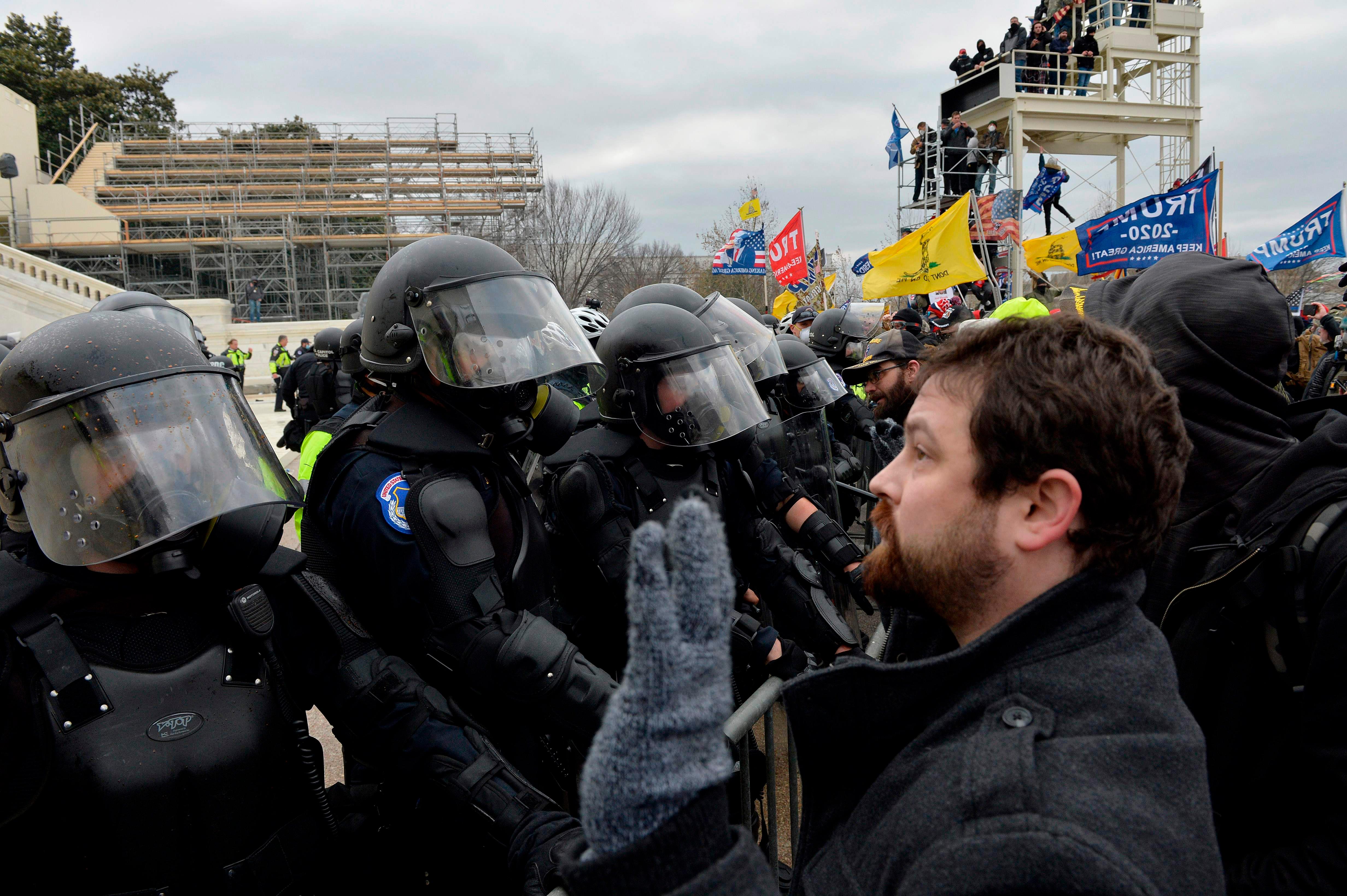 Supporters of US President Donald Trump clash with police and security forces as people try to storm the Capitol Building in Washington, DC on January 6, 2021. - Donald Trump's supporters stormed a session of Congress held today, January 6, to certify Joe Biden's election win, triggering unprecedented chaos and violence at the heart of American democracy and accusations the president was attempting a coup. (Photo by Joseph Prezioso / AFP)