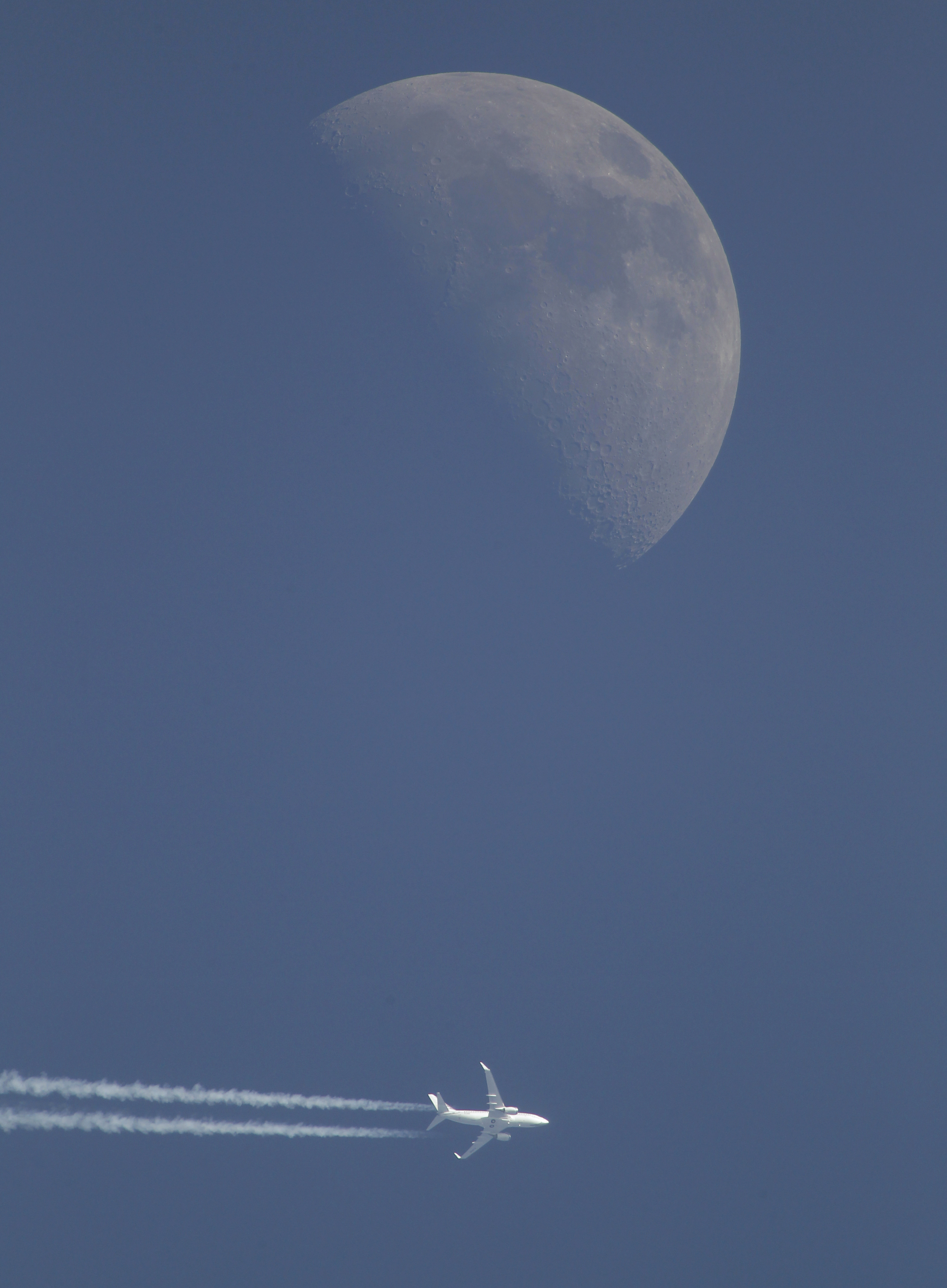 A jet airplane leaves a trail in the sky Sunday evening, April 29, 2012, over Novogrudok, 150 kilometers (93 miles) west of the capital Minsk, Belarus. The waxing crescent moon will be full May 6. (AP Photo/Sergei Grits)