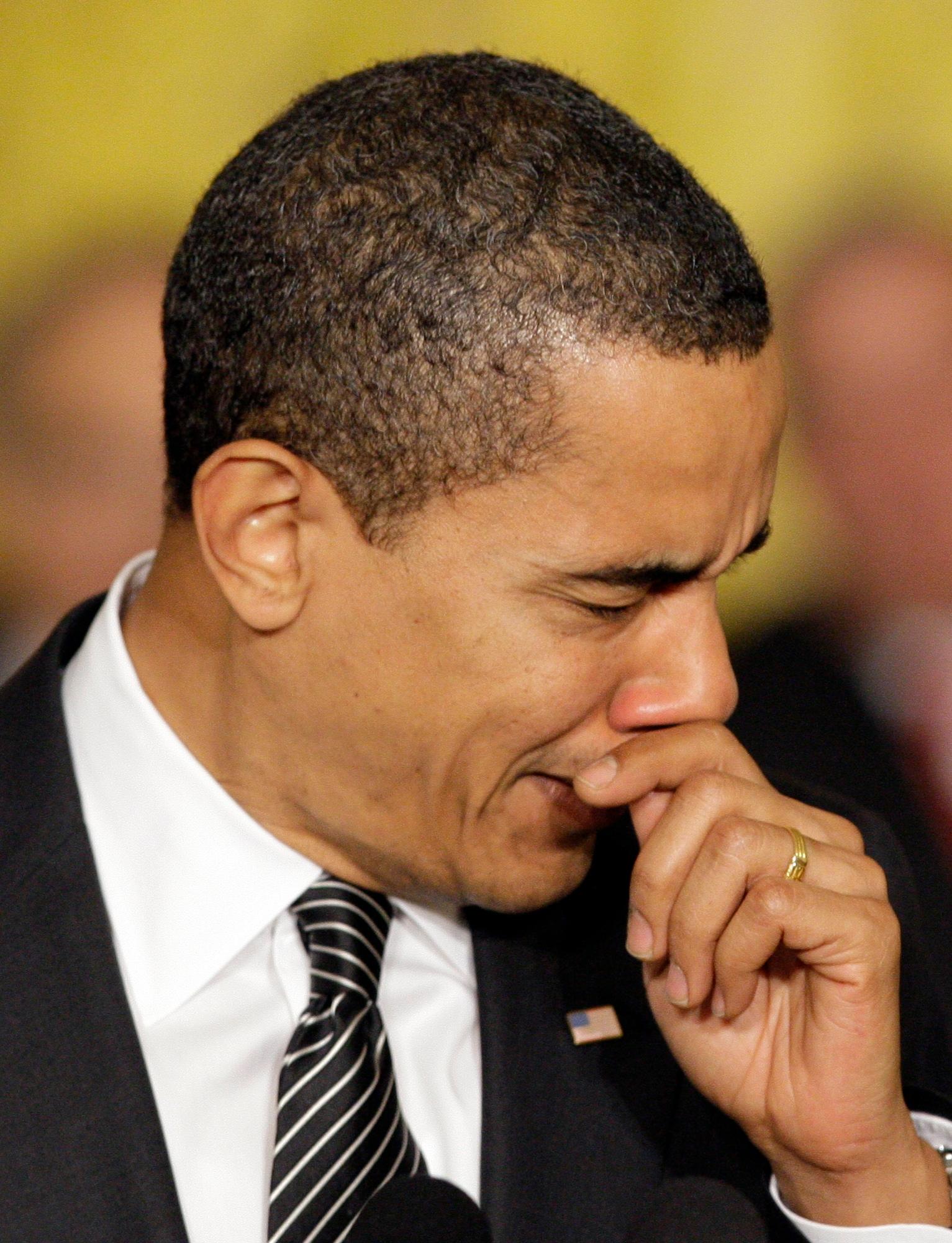 President Barack Obama covers his sneeze as he speaks about healthcare reform in the East Room of the White House in Washington Thursday, March 5, 2009.(AP Photo/Alex Brandon)