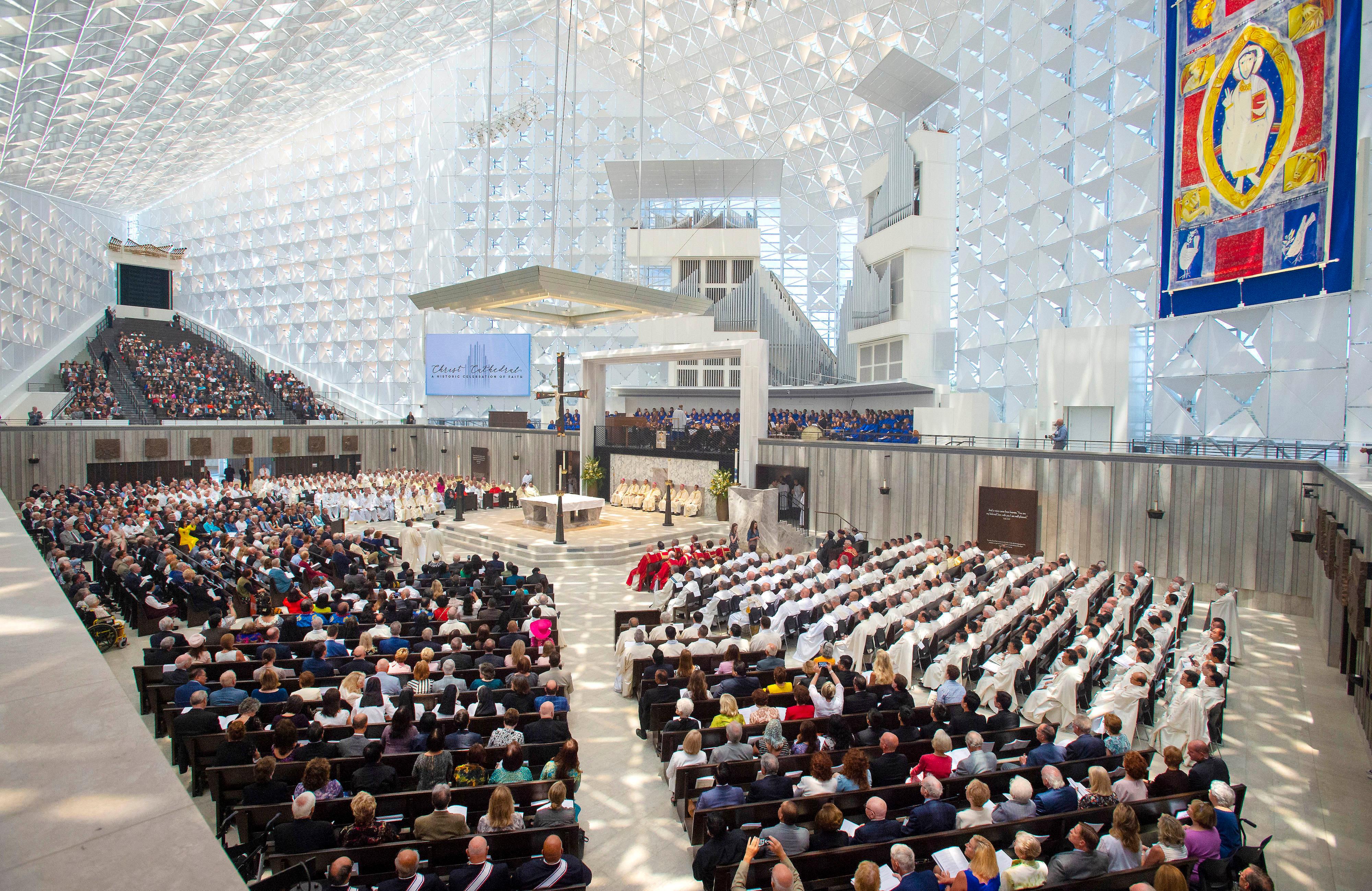 Guests attend the Christ Cathedral Solemn Mass of Dedication on Wednesday July 17, 2019, in Garden Grove, Calif. More than 2,000 guests attended the event that marked the opening of the building, now known as Christ Cathedral, the new home of the Diocese of Orange. The landmark was long known as Rev. Robert H. Schuller's Crystal Cathedral. (Mark Rightmire/The Orange County Register via AP)