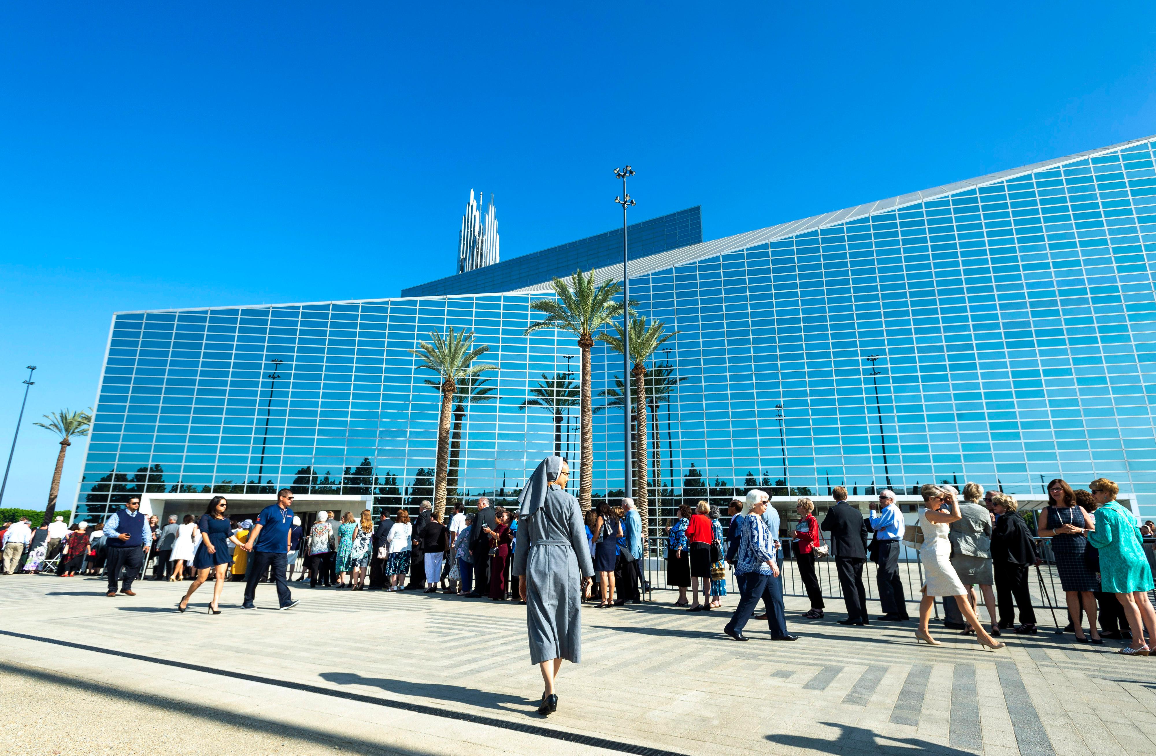 Guests arrive at the Christ Cathedral Solemn Mass of Dedication in Garden Grove, Calif., on Wednesday, July 17, 2019. More than 2,000 guests attended the event that marked the opening of the building, now known as Christ Cathedral, the new home of the Diocese of Orange. The landmark was long known as Rev. Robert H. Schuller's Crystal Cathedral. (Paul Bersebach/The Orange County Register via AP)