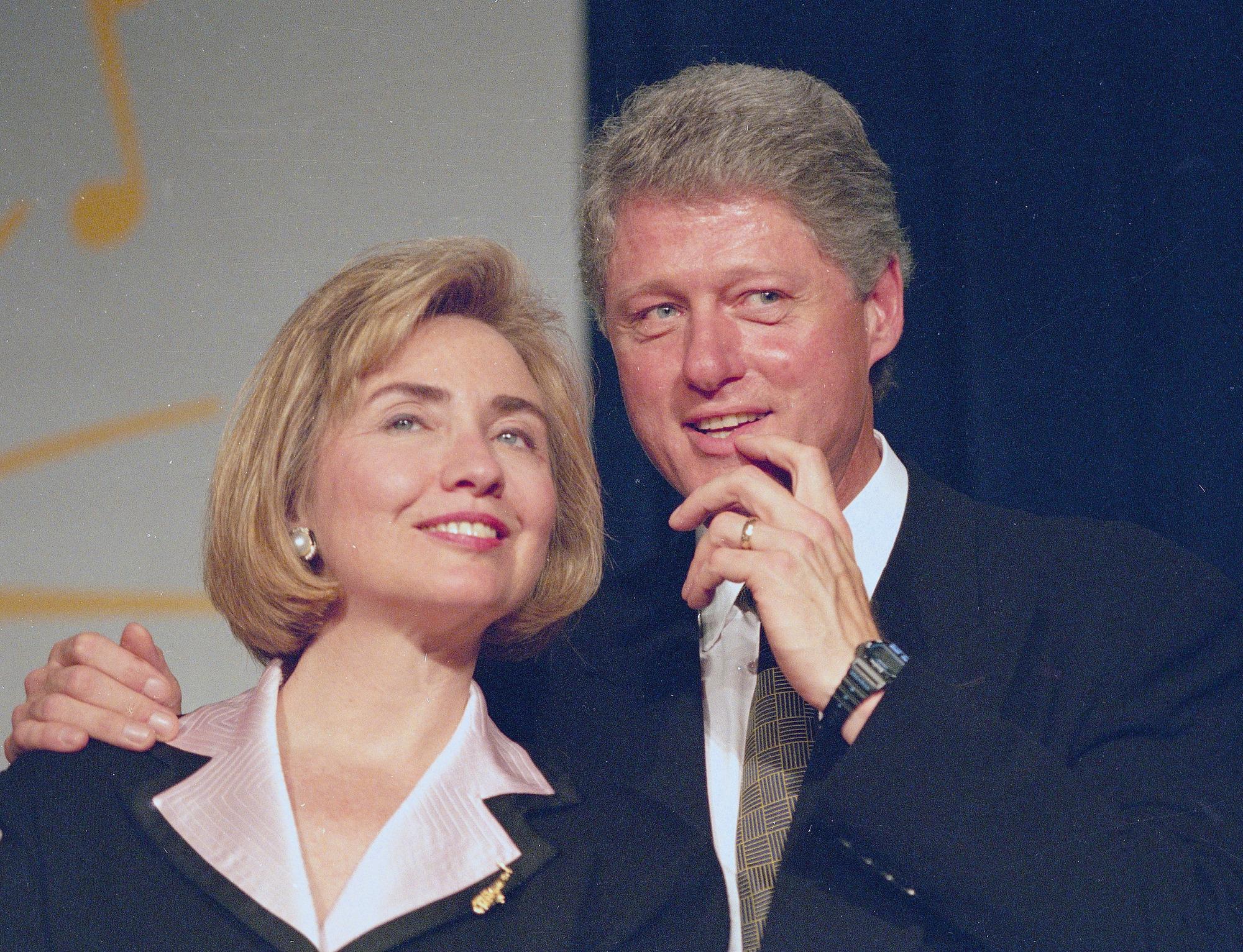 President Bill Clinton and first lady Hillary Rodham Clinton wait to address a group of young Democratic supporters known as the Saxophone Club in Washington, June 22, 1994.  The group cheered, whistled and stomped as a wound-up president delivered his stump speech and verbally thrashed Republicans who try to block health care reform legislation.  (AP Photo/J. Scott Applewhite)