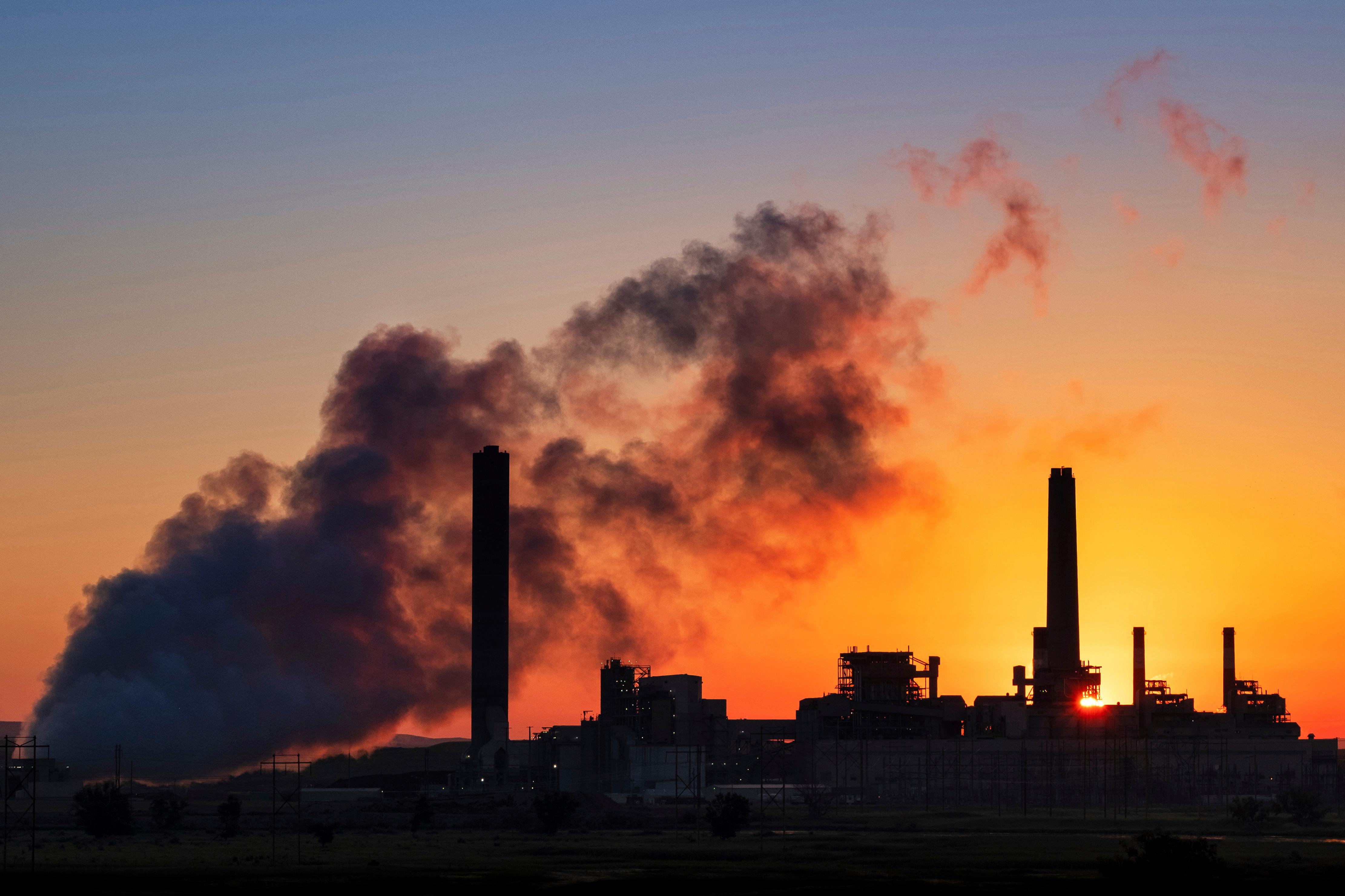 FILE - The Dave Johnson coal-fired power plant is silhouetted against the morning sun in Glenrock, Wyo., Friday,  July 27, 2018.  The Trump administration has weakened an Obama-era rule aimed at stopping coal plant pollution that has contaminated streams, lakes and underground aquifers. The changes finalized Monday, Aug. 31, 2020, will allow utilities to use cheaper wastewater cleanup technologies and take longer to comply with pollution reduction guidelines adopted in 2015. Its the latest in a string of regulatory rollbacks for the coal power industry under Trump. (AP Photo/J. David Ake, File)