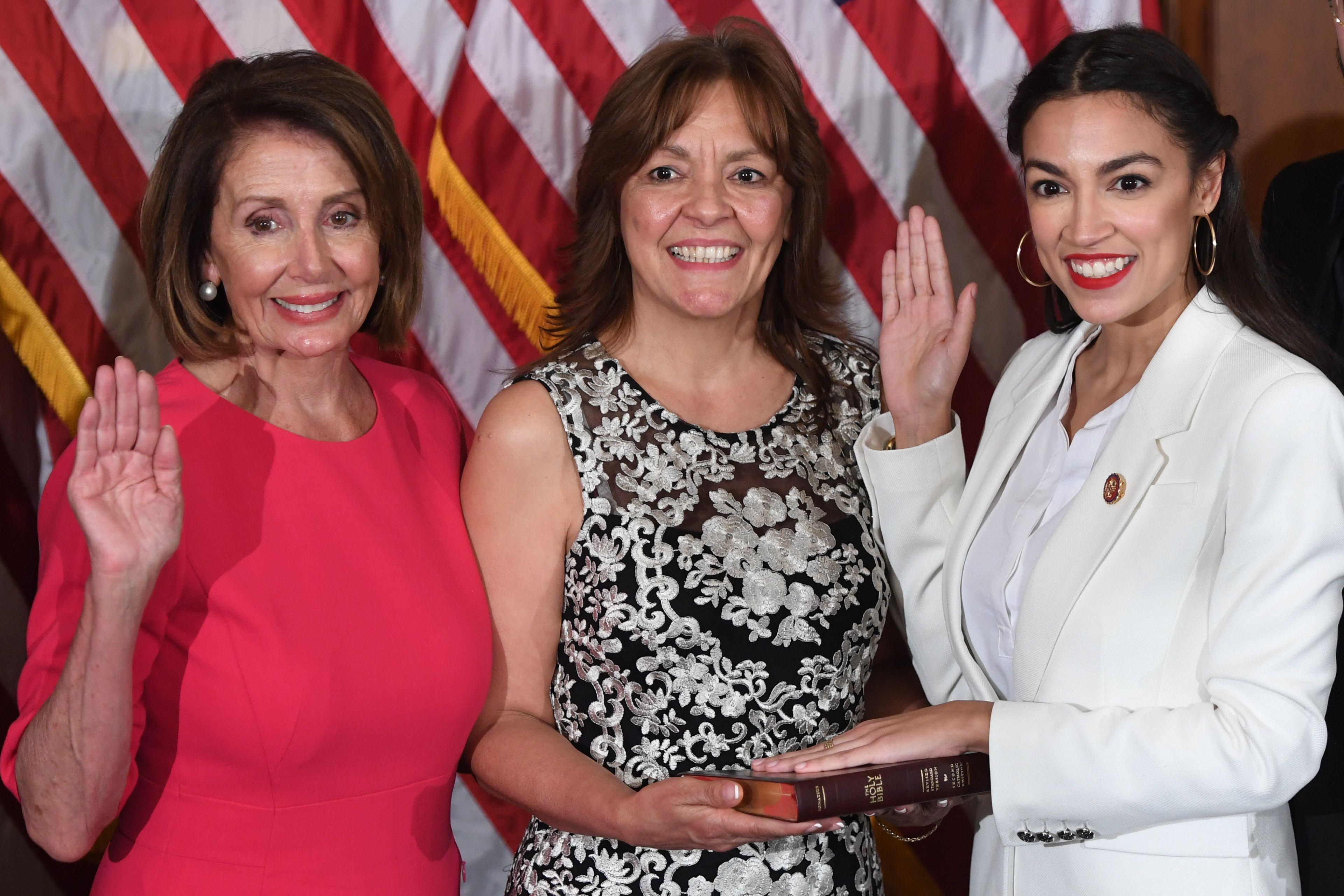 Speaker of the House Nancy Pelosi (L) performs a ceremonial swearing-in for US House Representative Alexandria Ocasio-Cortez (R), D-NY, at the start of the 116th Congress at the US Capitol in Washington, DC, January 3, 2019. (Photo by SAUL LOEB / AFP)