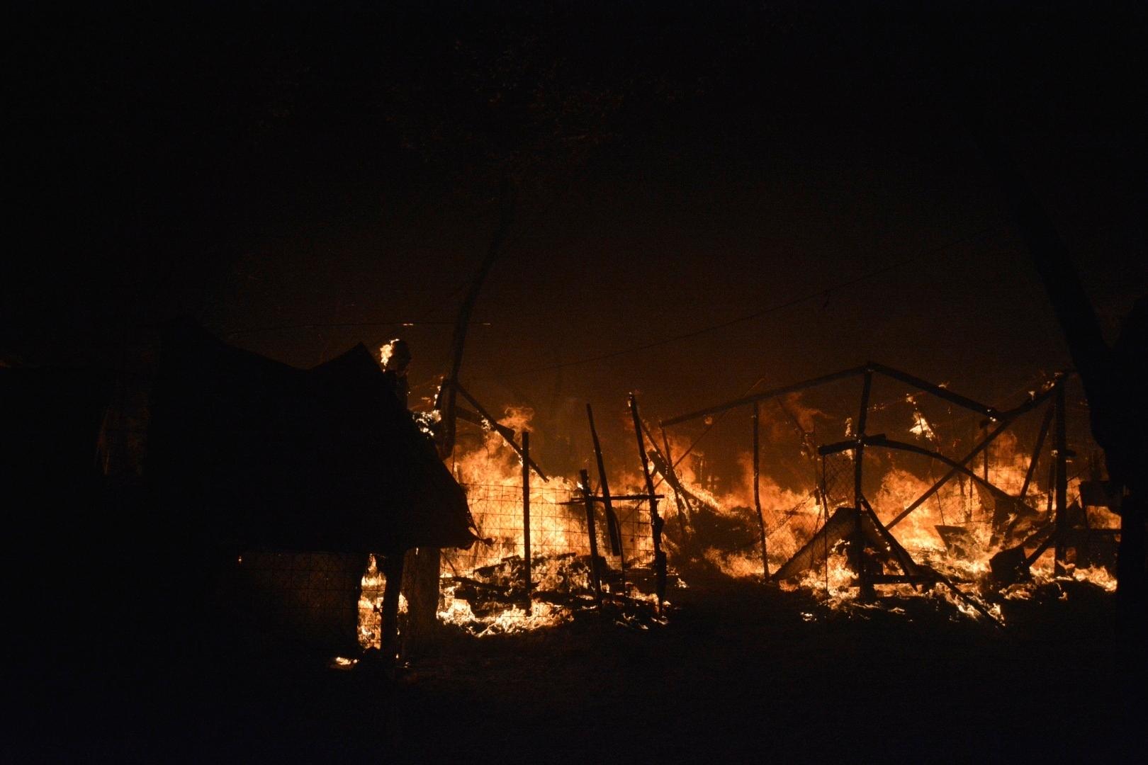 Fire burns makeshift tents at the Moria refugee camp on the northeastern Aegean island of Lesbos, Greece, on Wednesday, Sept. 9, 2020. Fire Service officials say a large refugee camp on the Greek island of Lesbos has been partially evacuated despite a COVID-19 lockdown after fires broke out at multiple points around the site early Wednesday. (AP Photo/Panagiotis Balaskas)