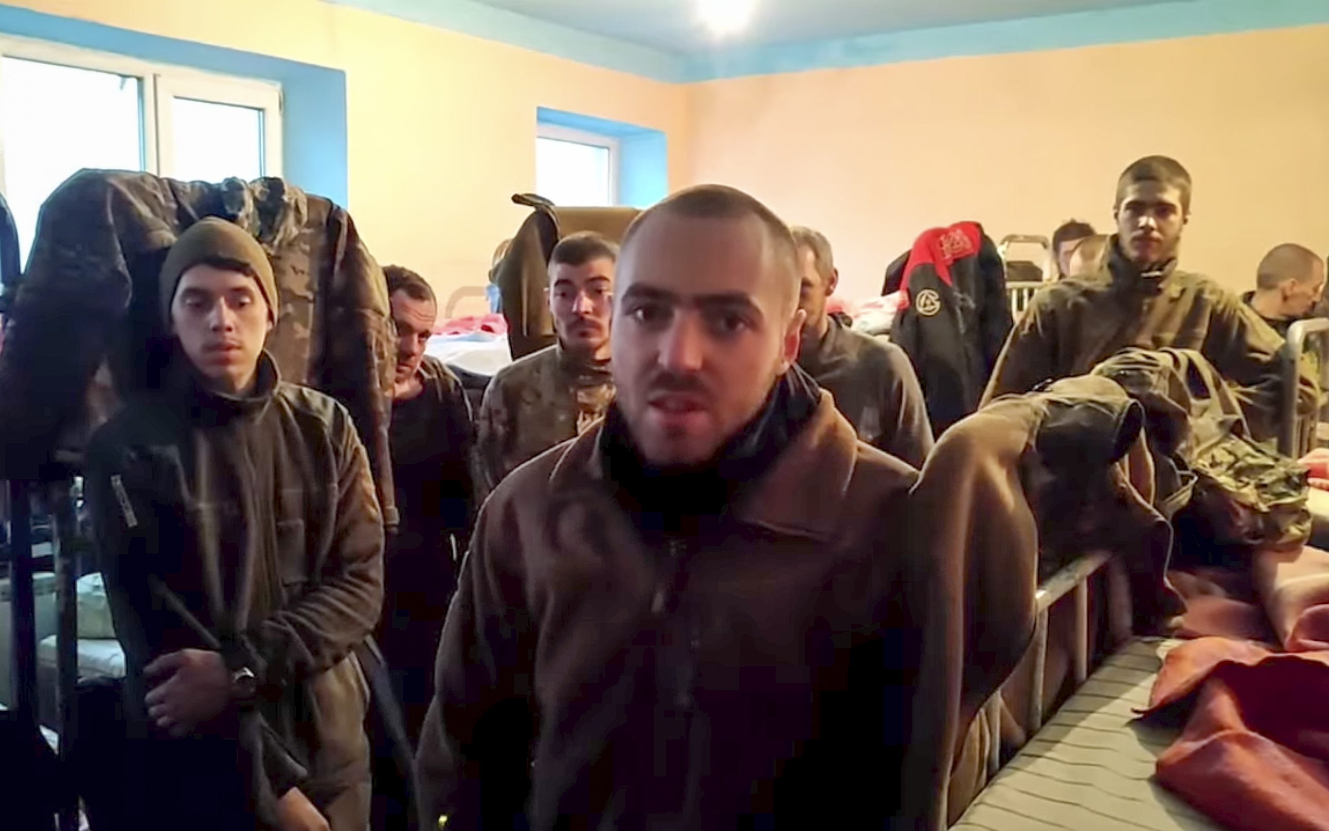 In this photo taken from a video released by the Russian Defense Ministry on Thursday, May 19, 2022, Ukrainian servicemen in a penal colony in Olyonivka, territory under the government of the Donetsk People's Republic's control, eastern Ukraine, after leaving the besieged Azovstal steel plant in Mariupol. (Russian Defense Ministry Press Service via AP)