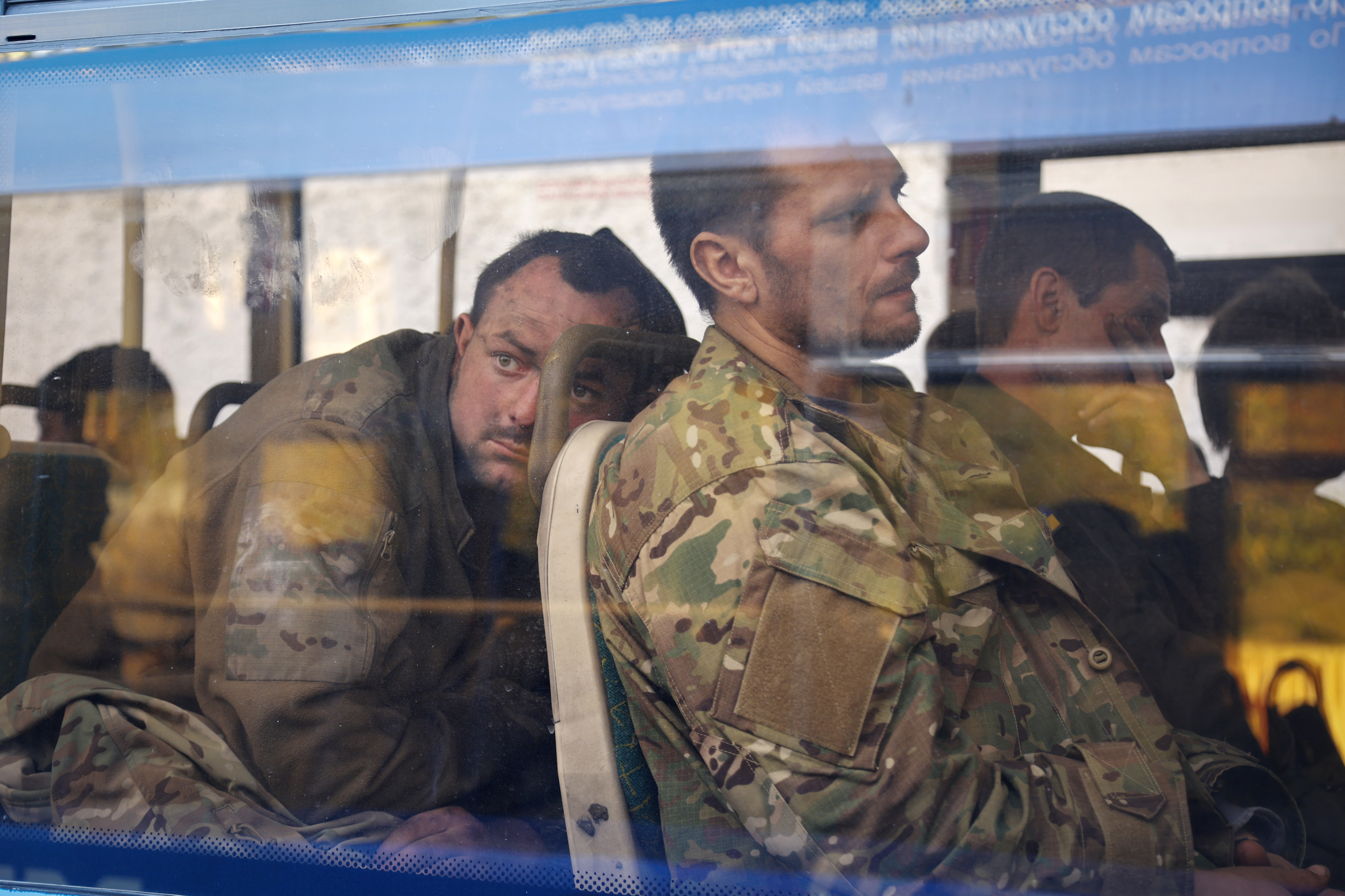 FILE - Ukrainian servicemen sit in a bus after they were evacuated from the besieged Mariupol's Azovstal steel plant, near a remand prison in Olyonivka, in territory under the government of the Donetsk People's Republic, eastern Ukraine, May 17, 2022. Three months after it invaded Ukraine hoping to overtake the country in a blitz, Russia has bogged down in what increasingly looks like a war of attrition with no end in sight. (AP Photo/Alexei Alexandrov, File)