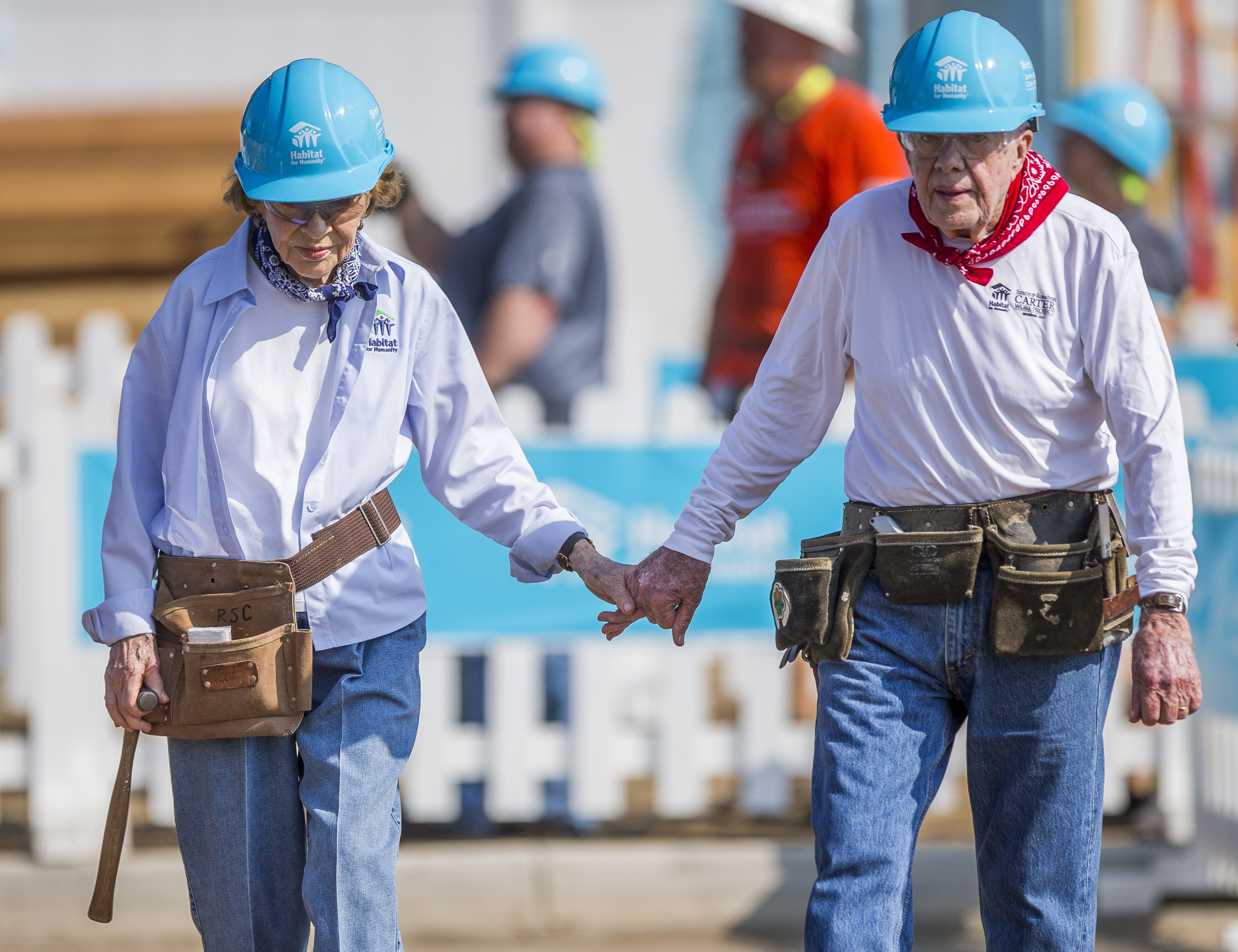 Former President Jimmy Carter holds hands with his wife, former first lady Rosalynn Carter, as they work with other volunteers on site during the first day of the weeklong Jimmy & Rosalynn Carter Work Project, their 35th work project with Habitat for Humanity, on Monday, Aug. 27, 2018, in Mishawaka, Ind. (Robert Franklin/South Bend Tribune via AP)