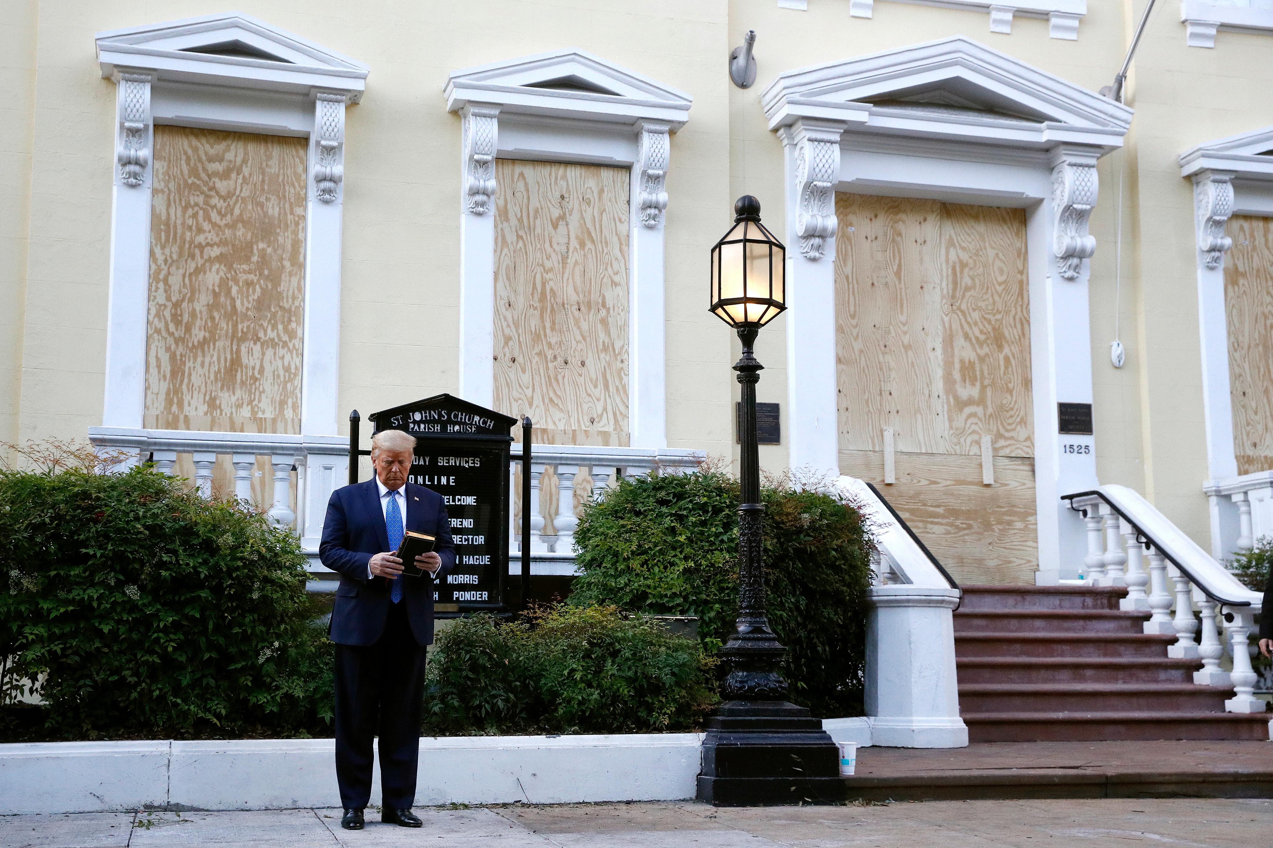 President Donald Trump holds a Bible as he visits outside St. John's Church across Lafayette Park from the White House Monday, June 1, 2020, in Washington. Part of the church was set on fire during protests on Sunday night. (AP Photo/Patrick Semansky)