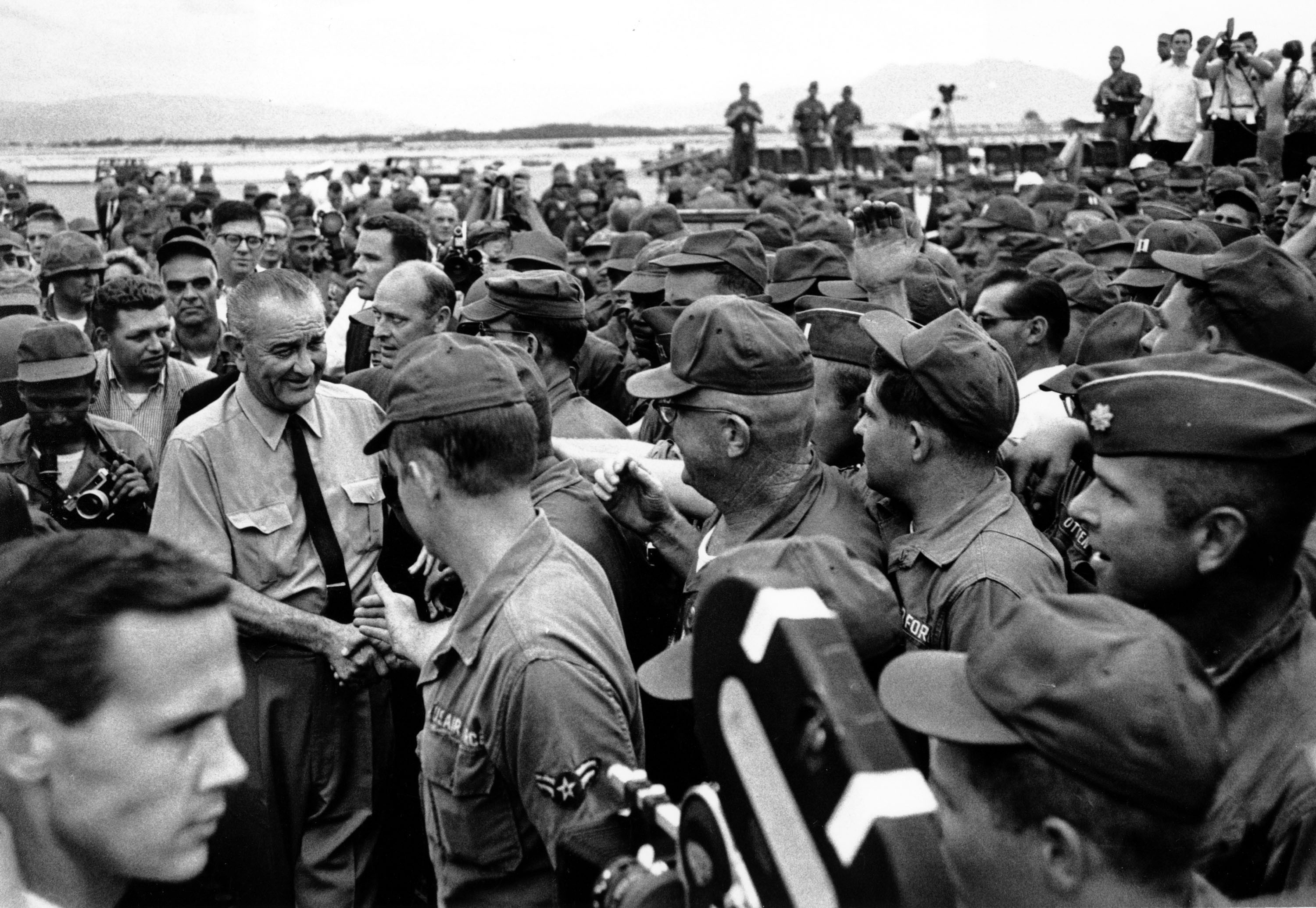 A crowd of American soldiers swarm around U.S. President Johnson on Oct. 26, 1966 shortly after his arrival at Cam Rahn Bay in South Vietnam visiting troops during the war.  (AP Photo)