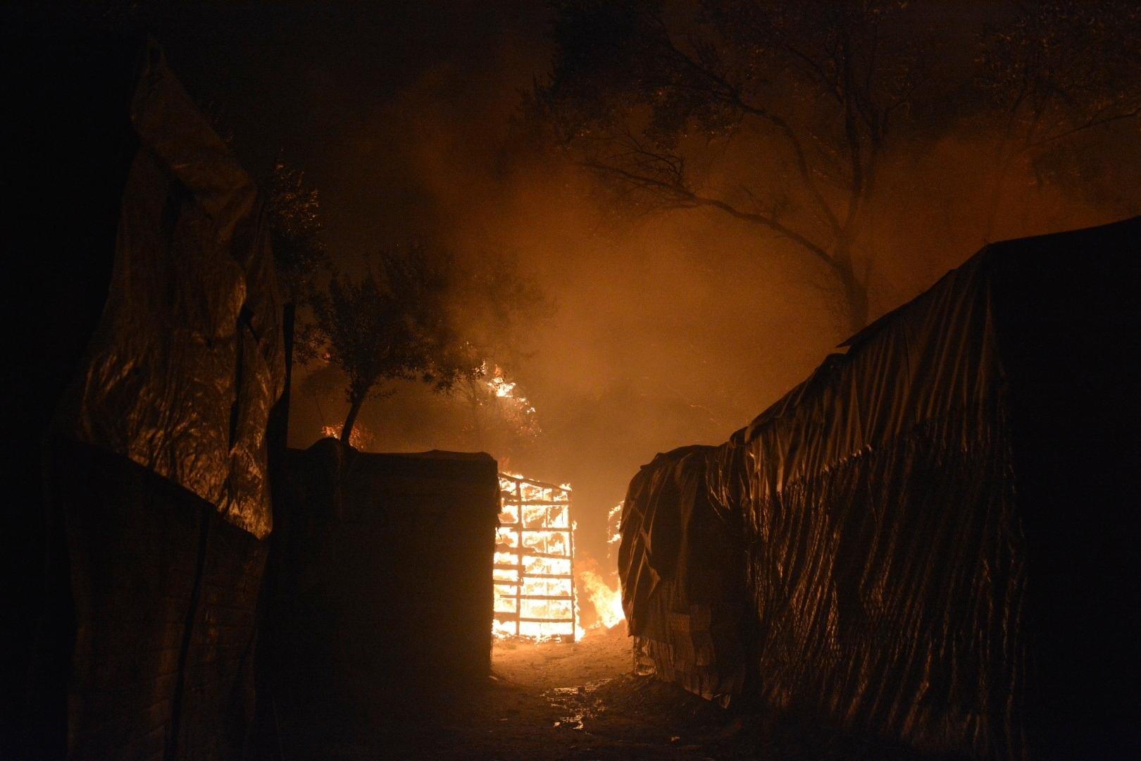 Fire burns makeshift tents at the Moria refugee camp on the northeastern Aegean island of Lesbos, Greece, on Wednesday, Sept. 9, 2020. Fire Service officials say a large refugee camp on the Greek island of Lesbos has been partially evacuated despite a COVID-19 lockdown after fires broke out at multiple points around the site early Wednesday. (AP Photo/Panagiotis Balaskas)