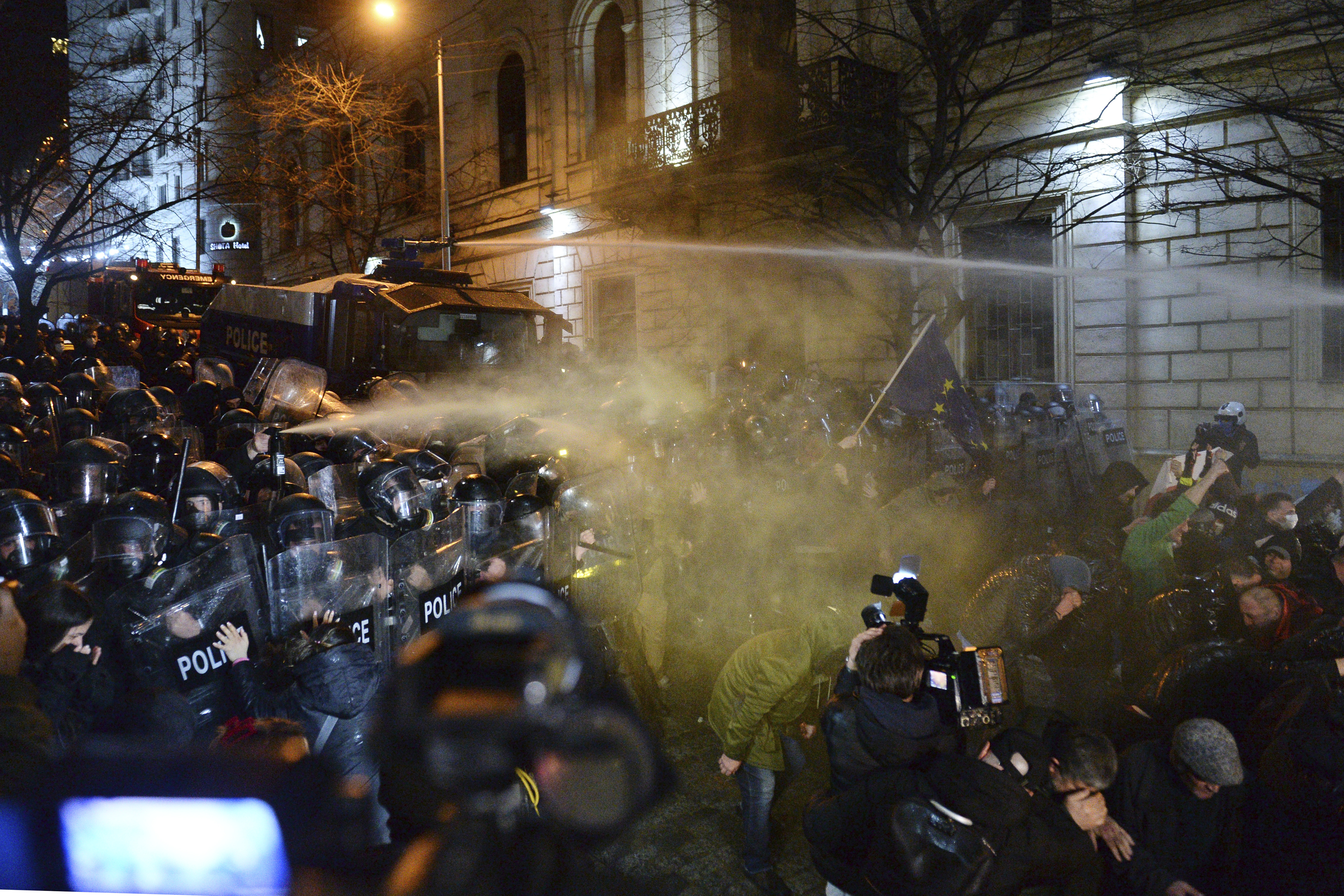 Politiet brukte vannkanoner og tåregass mot demonstranter utenfor nasjonalforsamlingen i Georgias hovedstad Tbilisi tirsdag. Foto: AP / NTB