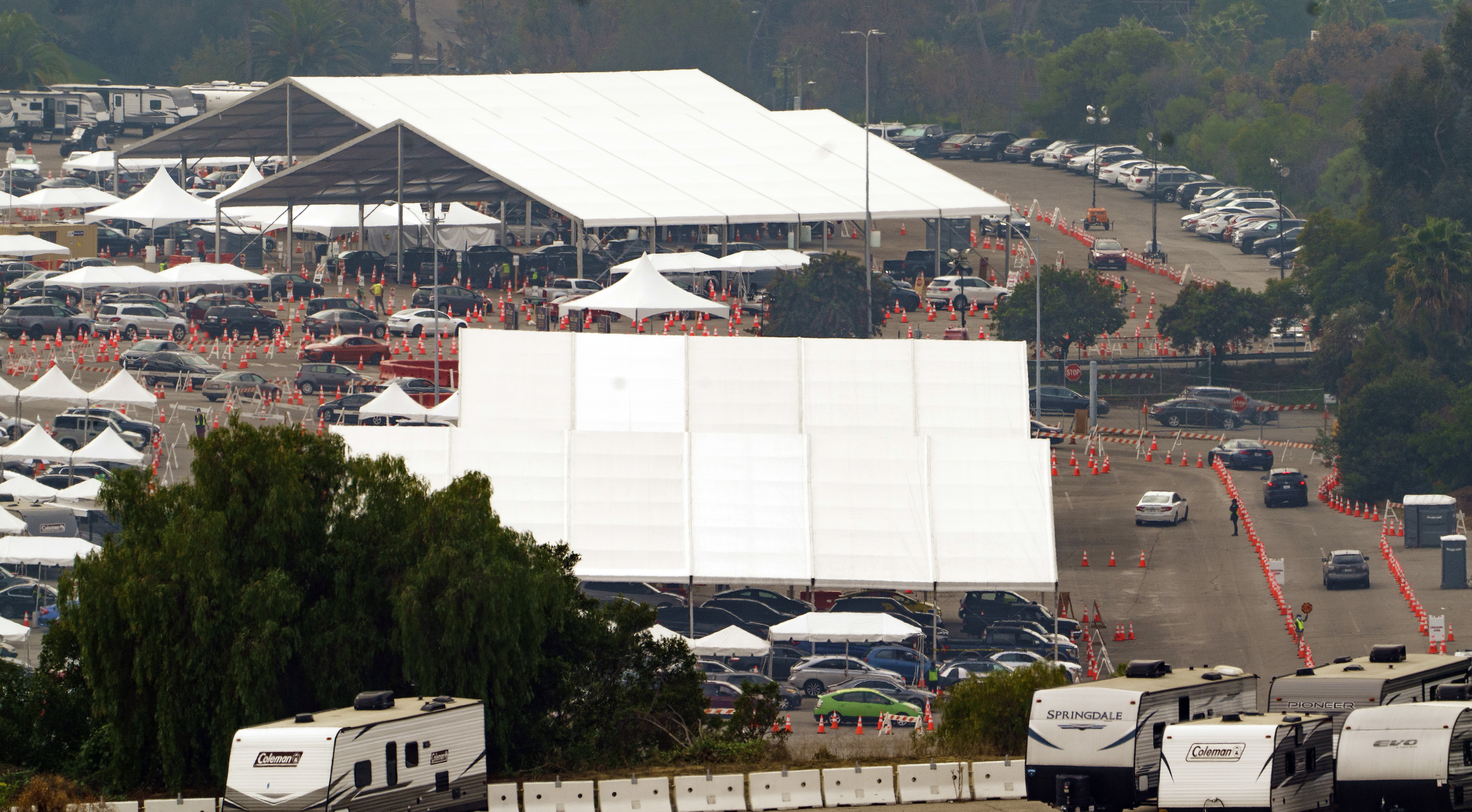 Motorists receive COVID-19 vaccines under large tents at a Los Angeles County location at Dodger Stadium in Los Angeles, Wednesday, Feb. 10, 2021. (AP Photo/Damian Dovarganes)