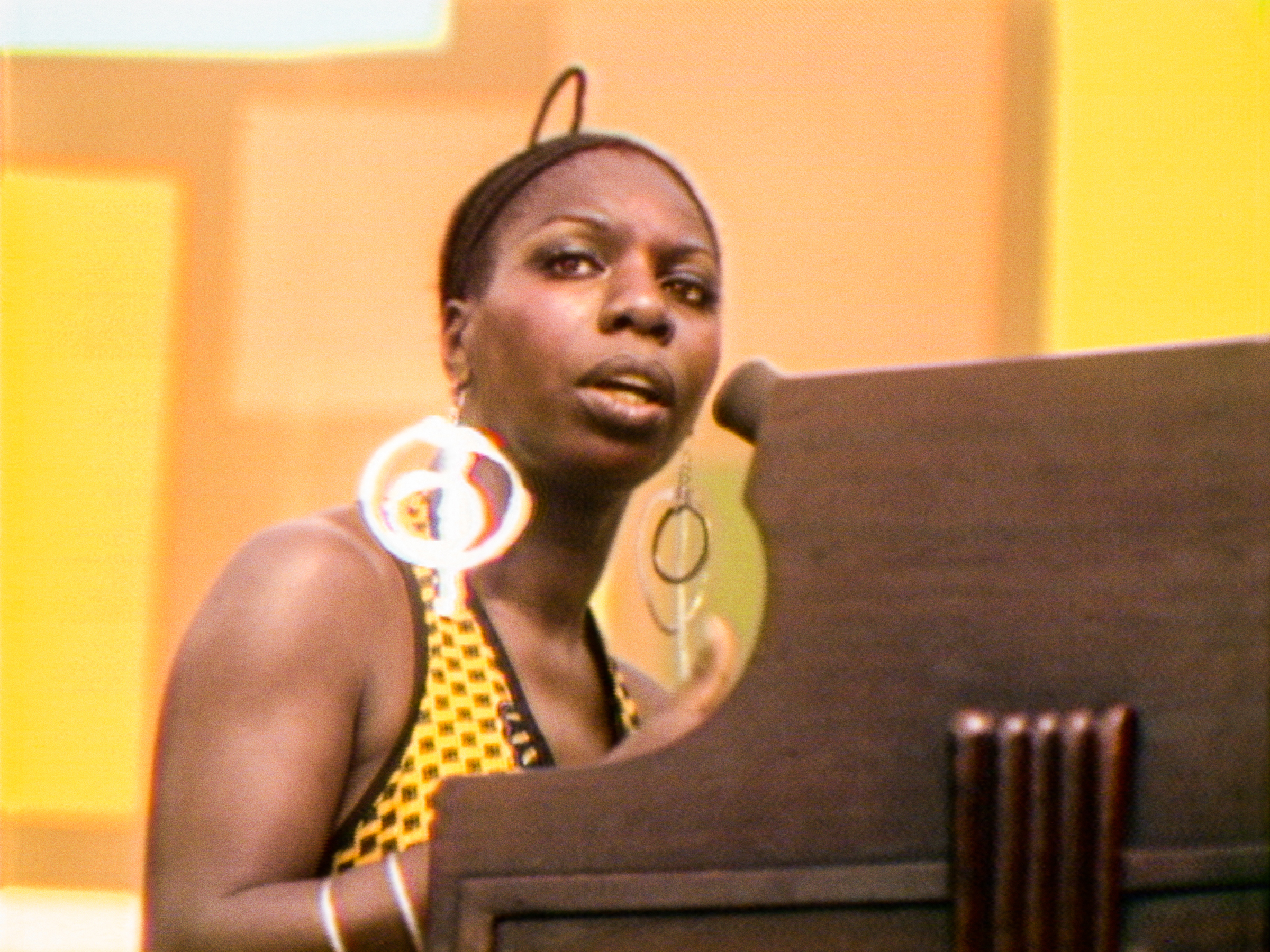 Nina Simone performs at the Harlem Cultural Festival in 1969, featured in the documentary SUMMER OF SOUL. Photo Courtesy of Searchlight Pictures. © 2021 20th Century Studios All Rights Reserved