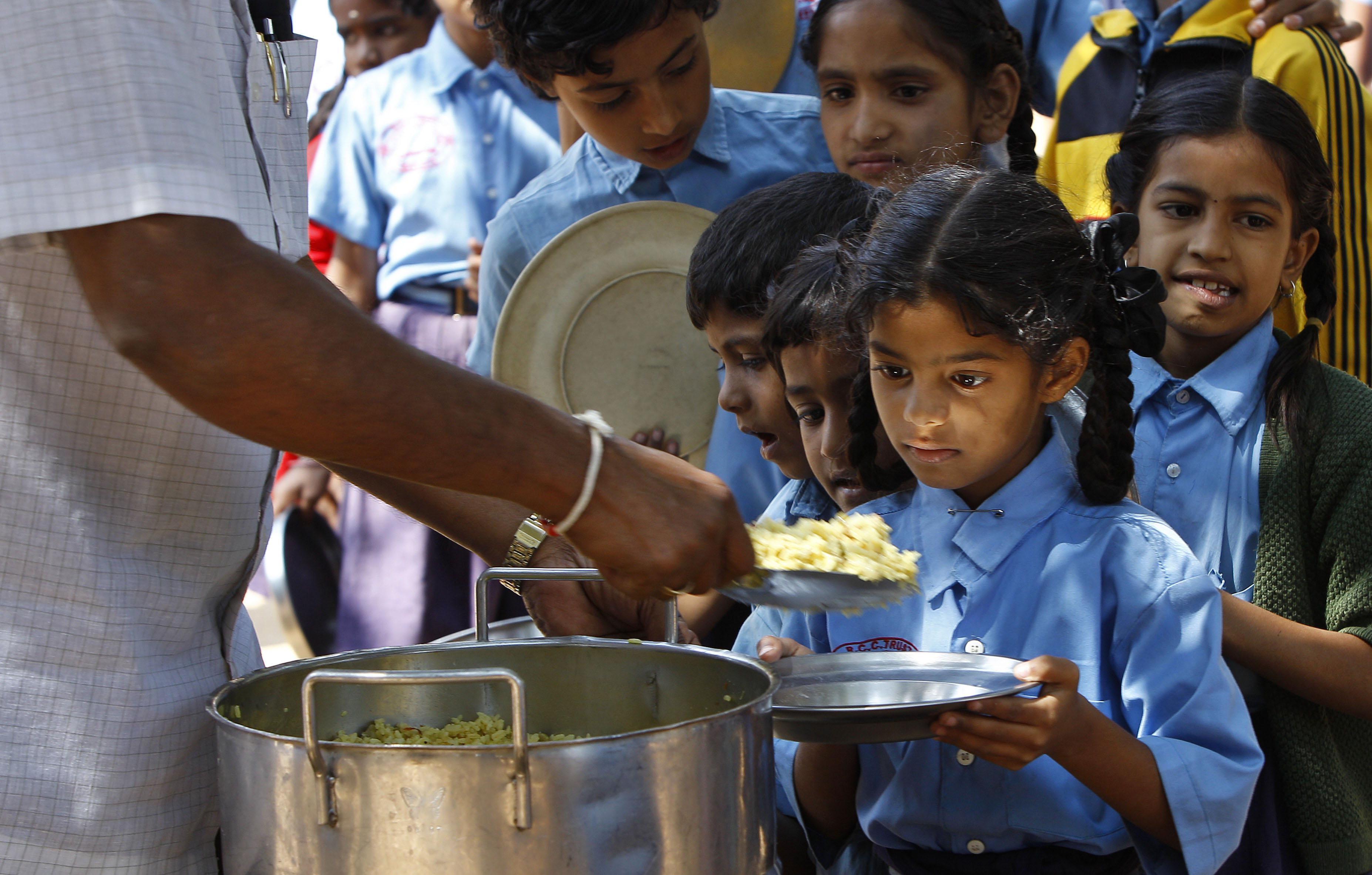 A girl looks at food served to her for free at a government-run school in Bangalore, India, Wednesday, Jan. 11, 2012. UNICEF's latest data say one-third of the world's malnourished children younger than 3 lives in India, a rate worse than sub-Saharan Africa. Indian Prime Minister Manmohan Singh has called child malnutrition the country's shame. (AP Photo/Aijaz Rahi)