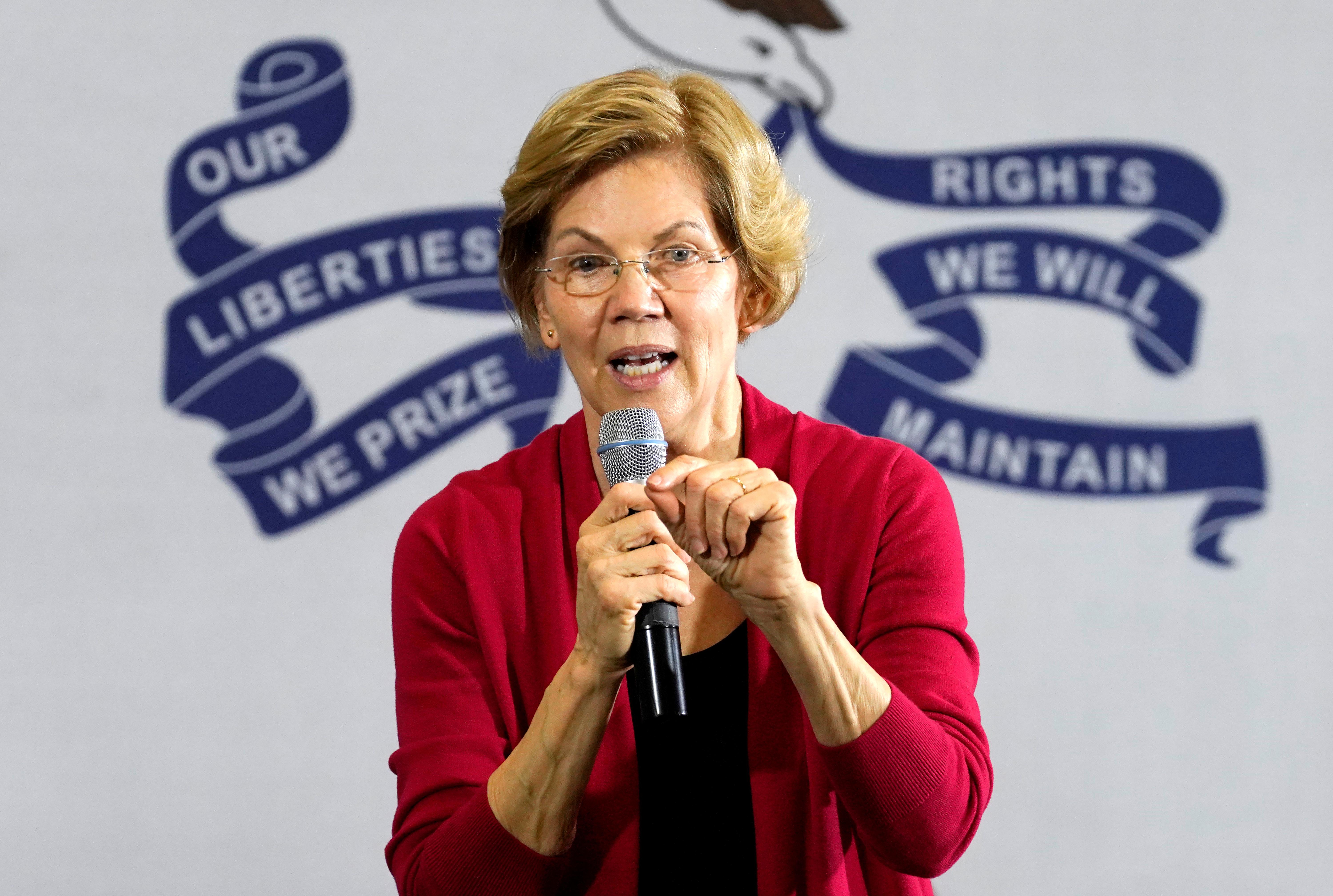 Democratic 2020 U.S. presidential candidate and U.S. Senator Elizabeth Warren (D-MA) is framed by the words on the Iowa flag at a campaign event in Indianola, Iowa, U.S., February 2, 2020. REUTERS/Rick Wilking