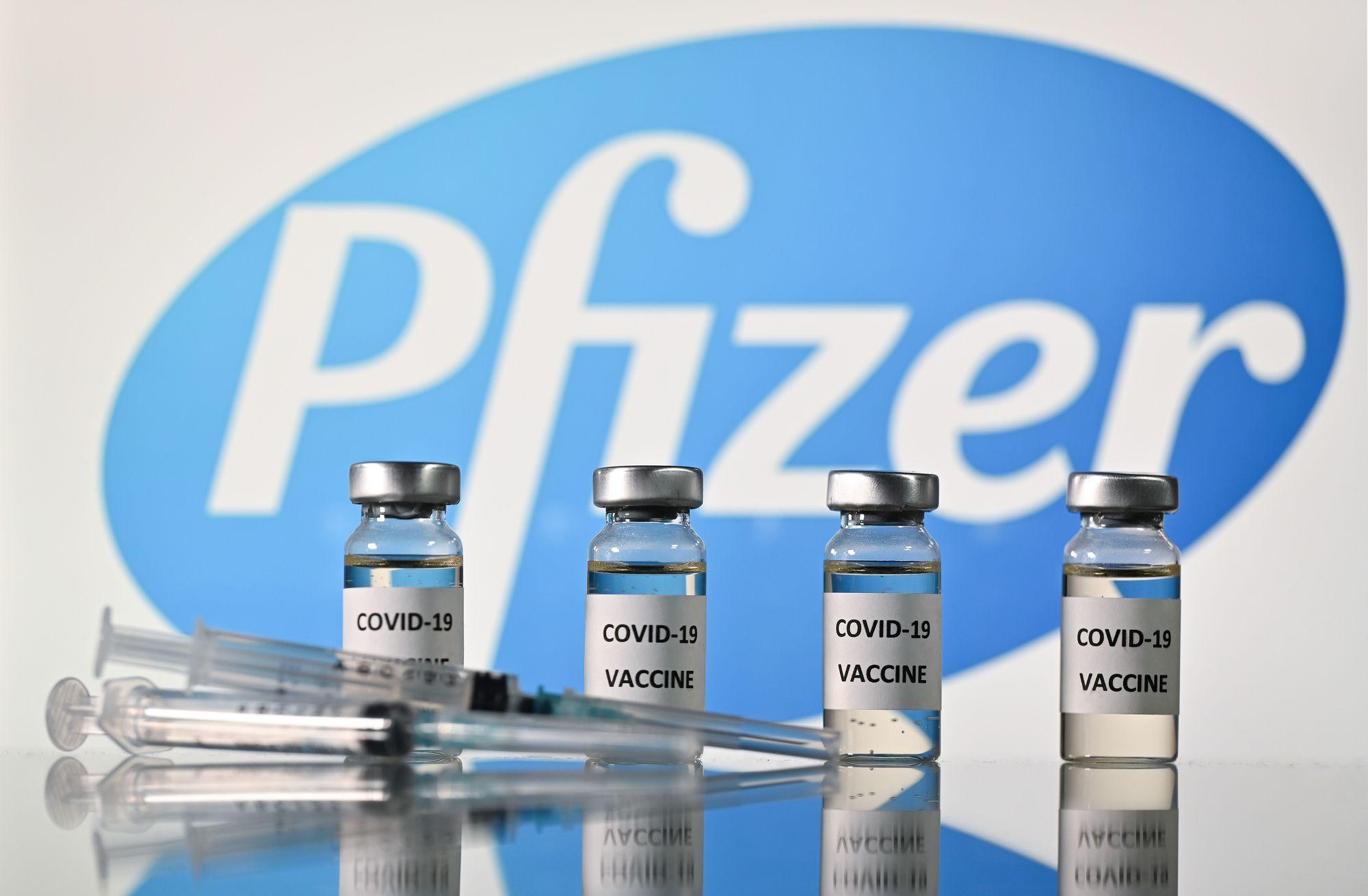 (FILES) In this file photo taken on November 17, 2020 An illustration picture shows vials with Covid-19 Vaccine stickers attached and syringes with the logo of US pharmaceutical company Pfizer, on November 17, 2020. - Britain on December 2, 2020 became the first country to approve Pfizer-BioNTech's Covid-19 vaccine for general use and said it would be introduced next week. (Photo by JUSTIN TALLIS / AFP)