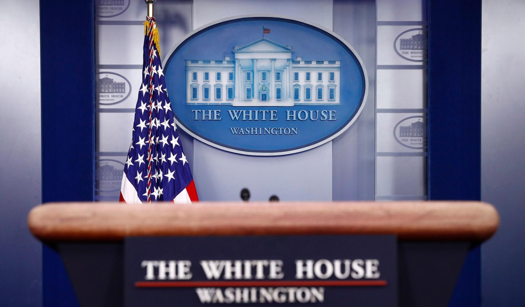 FILE - In this March 22, 2020, file photo a plaque depicting the White House is posted behind a podium in the James Brady Press Briefing Room of the White House in Washington. When Joe Biden takes the oath of office Wednesday, Jan. 20, 2021, he will begin to reshape the office of the presidency itself as he sets out to lead a bitterly divided nation grappling with a devastating pandemic and an insurrection meant to stop his ascension to power. (AP Photo/Patrick Semansky, File)