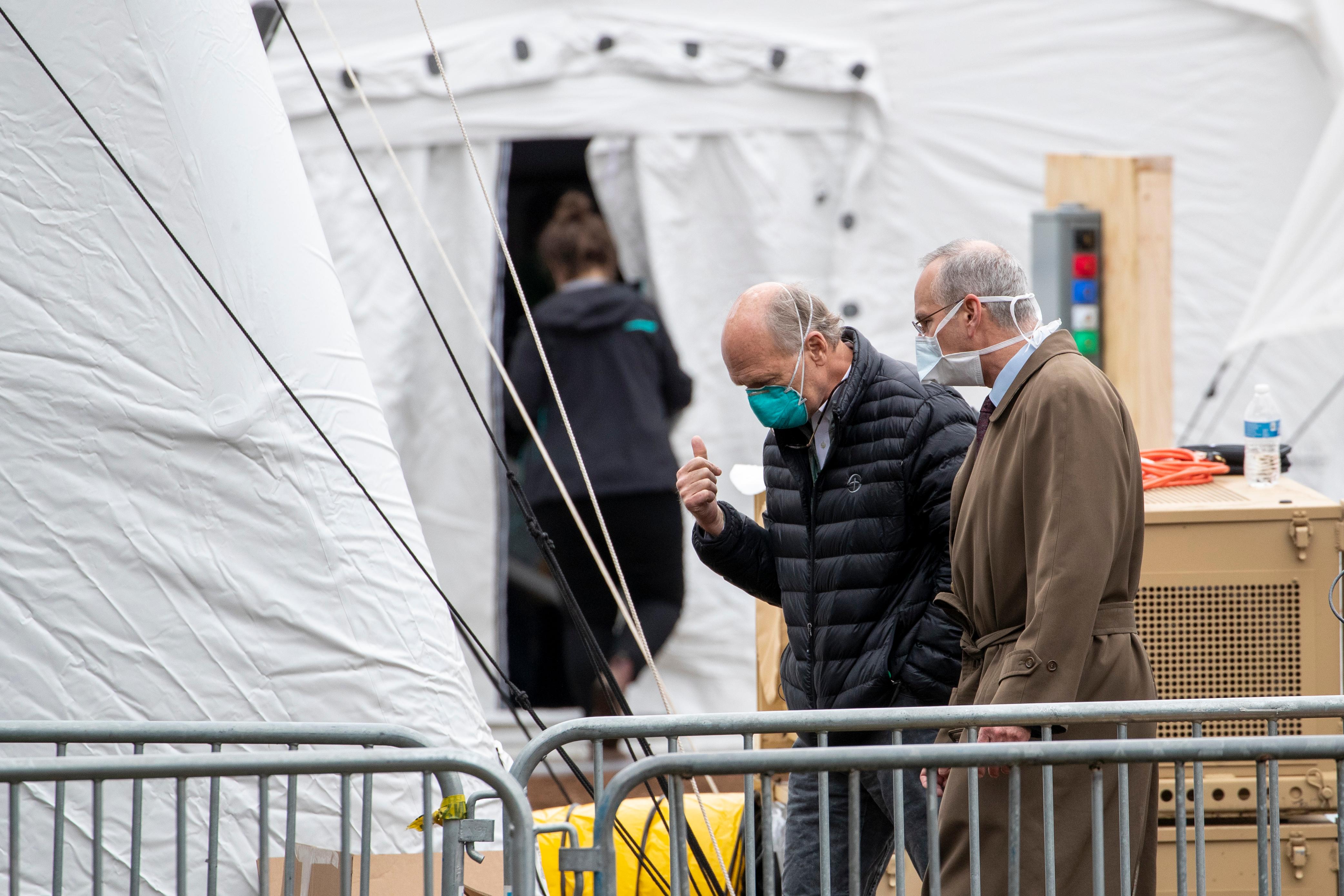 David L. Reich, President & Chief Operating Officer of The Mount Sinai Hospital, right, tours the Samaritan's Purse 68 bed emergency field hospital especially equipped with a respiratory unit in New York's Central Park, Tuesday, March 31, 2020, in New York. The new coronavirus causes mild or moderate symptoms for most people, but for some, especially older adults and people with existing health problems, it can cause more severe illness or death. (AP Photo/Mary Altaffer)