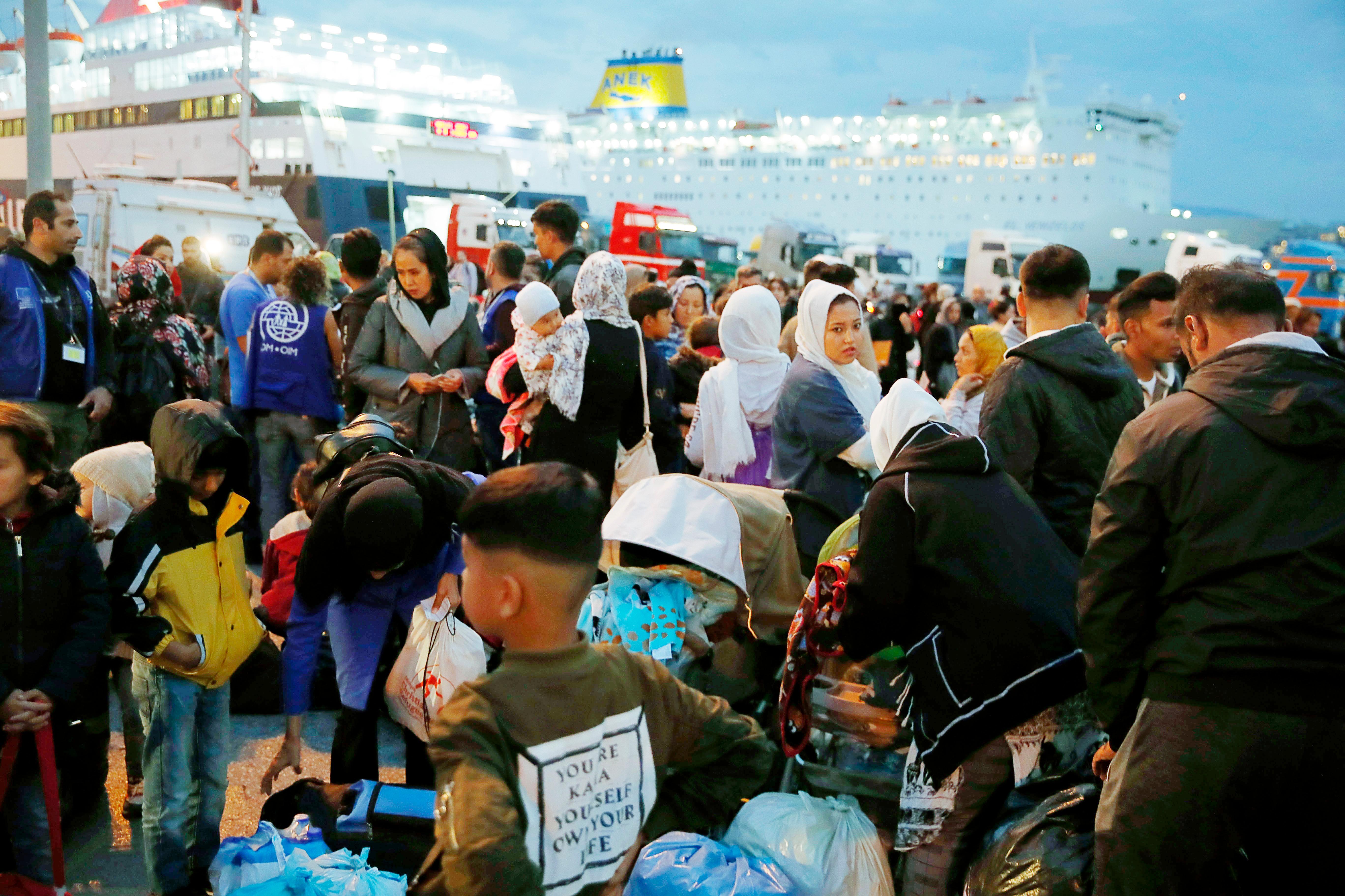 Migrants and refugees arrive from Lesbos island to the port of Piraeus, near Athens, Monday Oct. 7, 2019. In the last 24 hours 668 refugees and migrants have been transferred to mainland Greece from five Greek islands as authorities have accelerated efforts to ease over crowding in the camps. (AP Photo/Thanassis Stavrakis)  XTS108