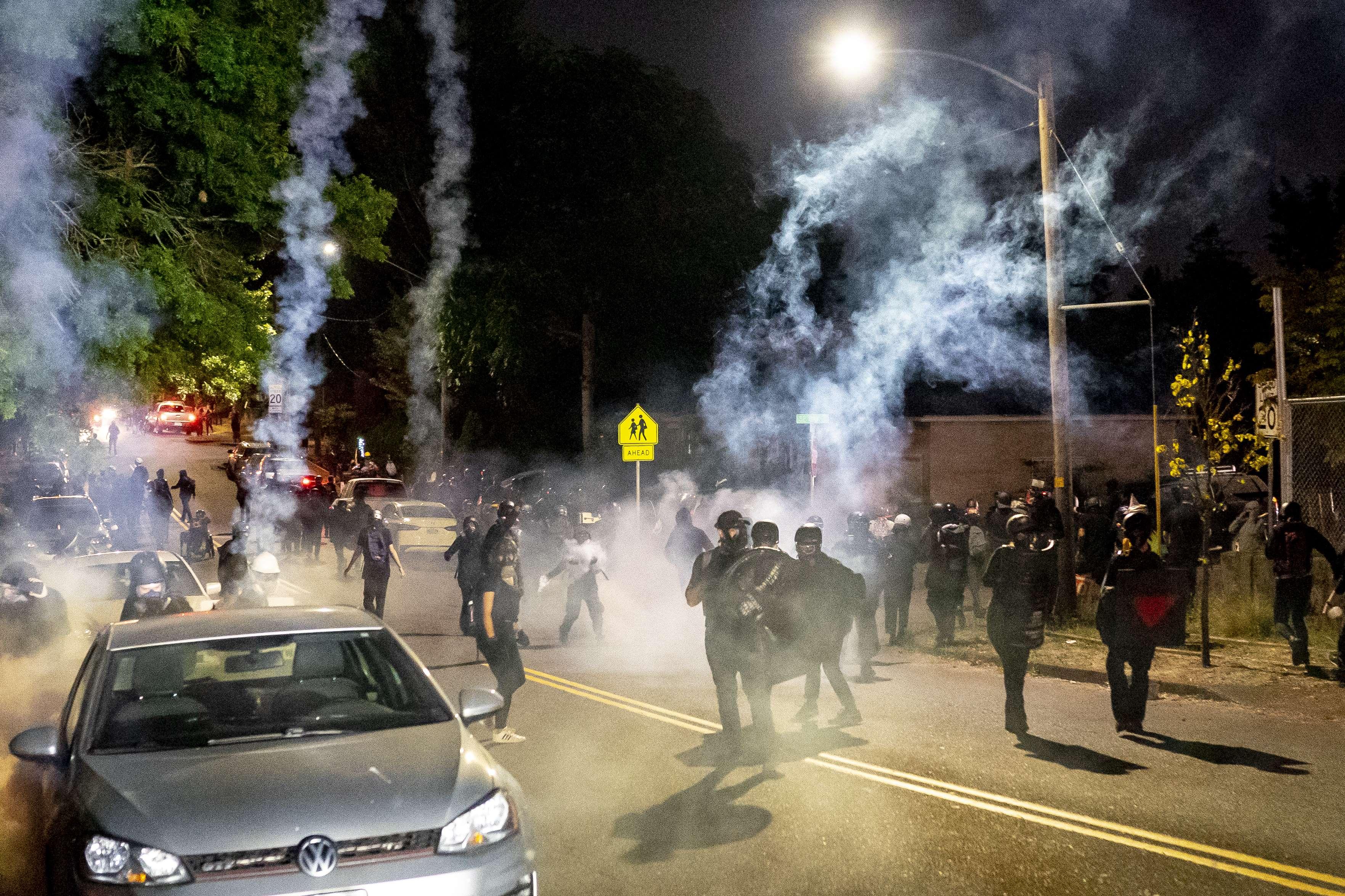 VANCOUVER WASH - SEPTEMBER 5: Protesters retreat through tear gas as Portland police disperse a protest against police brutality and racial injustice on September 5, 2020 in Portland, Oregon. Portland has seen nightly protests for the past 100 days following the death of George Floyd in police custody.   Nathan Howard/Getty Images/AFP
== FOR NEWSPAPERS, INTERNET, TELCOS & TELEVISION USE ONLY ==