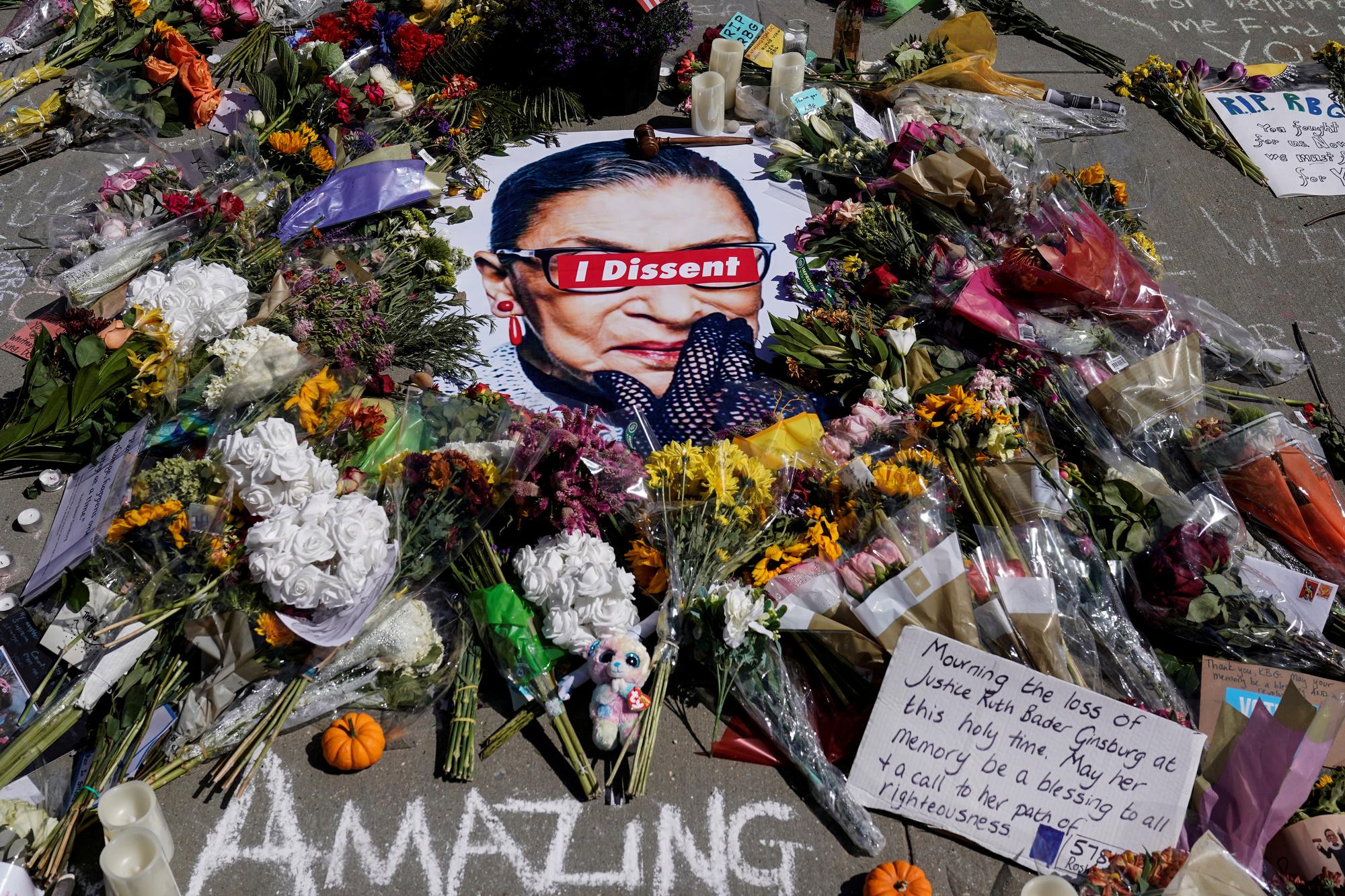 Flowers are placed at the Supreme Court as people mourn the death of Associate Justice Ruth Bader Ginsburg, in Washington, U.S., September 20, 2020.      REUTERS/Joshua Roberts