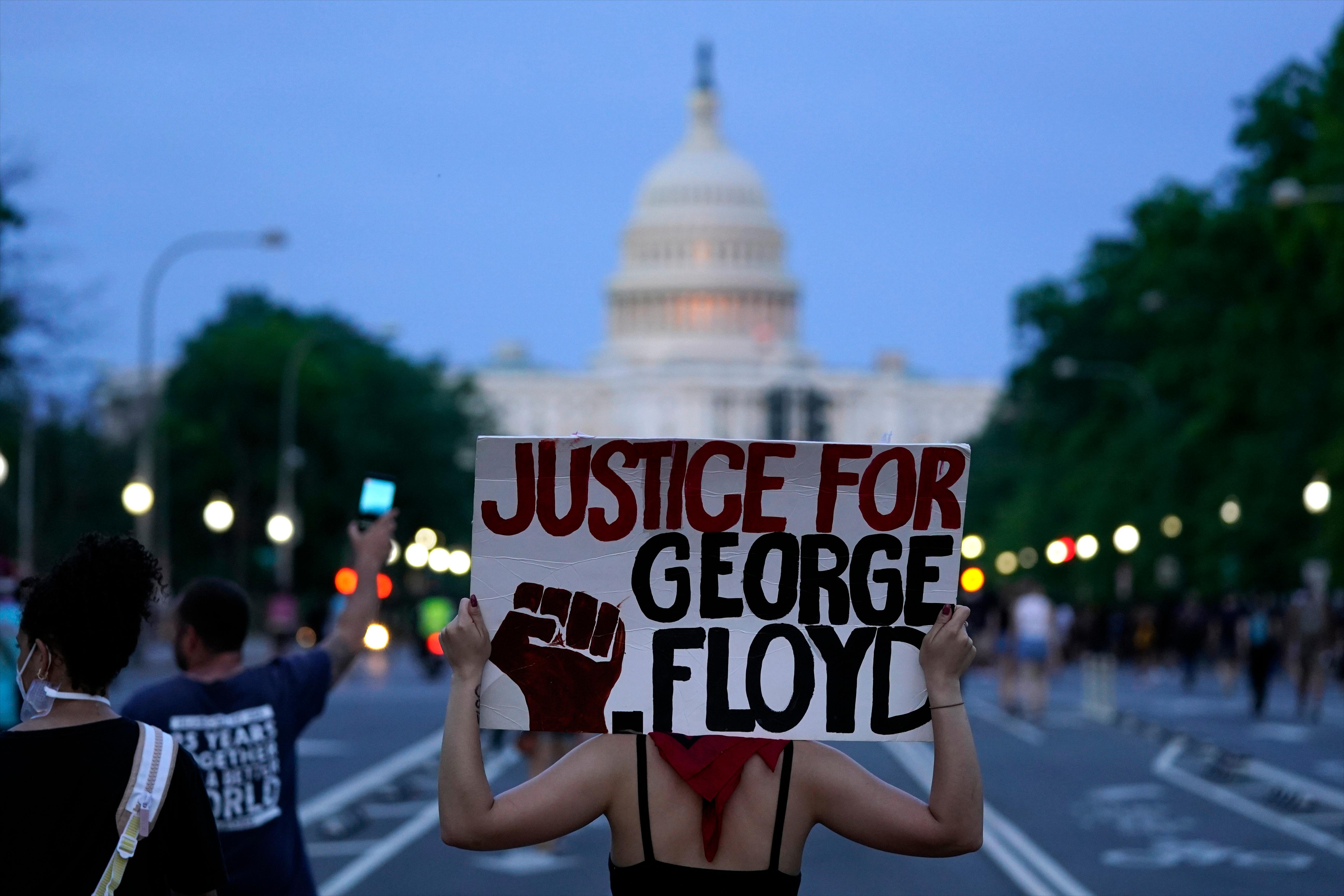 FILE - In this May 29, 2020, file photo, Demonstrators walk along Pennsylvania Avenue as they protest the death of George Floyd, a black man who died in police custody in Minneapolis in Washington. Black activists are coming out strongly against a growing narrative among conservatives that equates last weeks deadly siege on the U.S. Capitol to last summers Black Lives Matter protests over racial injustice. (AP Photo/Evan Vucci, File)