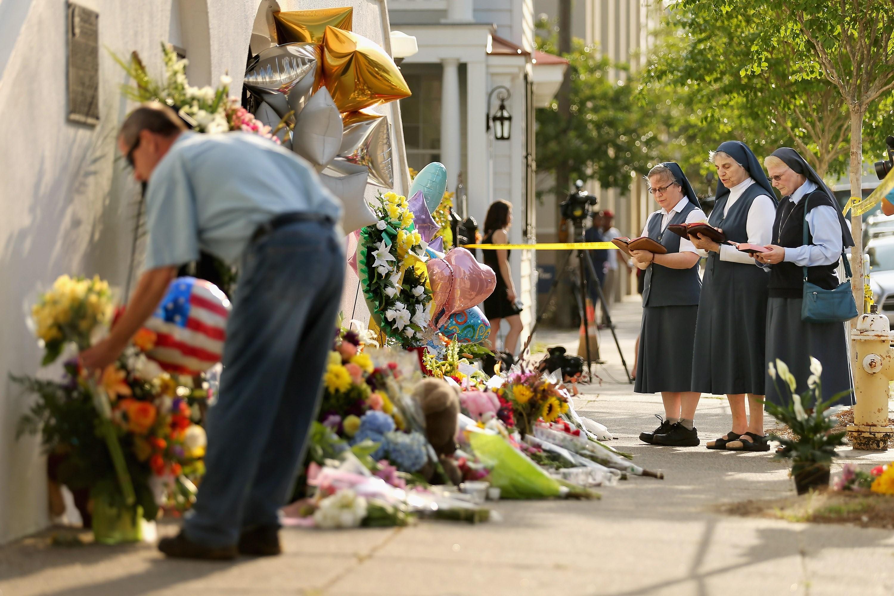 CHARLESTON, SC - JUNE 19: (L-R) Sisters Margaret Kerry, Mary Thecla and Kathleen Lang of the Order of the Daughters of St. Paul pray outside the historic Emanuel African Methodist Episcopal Church June 19, 2015 in Charleston, South Carolina. South Carolina Governor Nikki Haley called for the death penalty for Dylann Storm Roof, 21, of Lexington, South Carolina, if he is found guilty of murdering nine people during a prayer meeting at the church Wednesday night. Among the dead is the Rev. Clementa Pinckney, the pastor of the church which, according to the National Park Service, is the oldest black congregation in America south of Baltimore.   Chip Somodevilla/Getty Images/AFP
== FOR NEWSPAPERS, INTERNET, TELCOS & TELEVISION USE ONLY ==