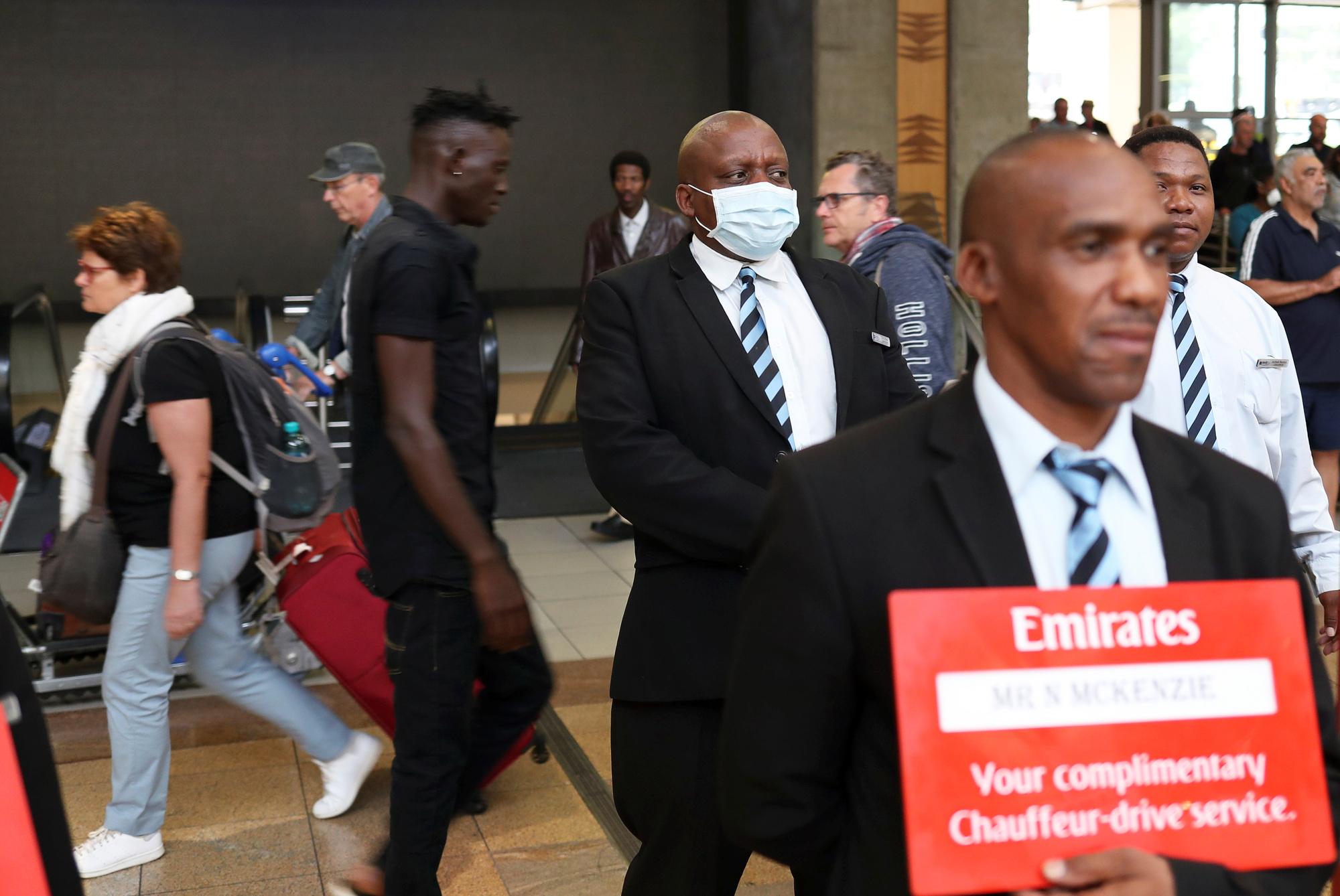 An airport worker in a protective mask waits for clients at the O. R. Tambo International Airport (ORTIA) in Kempton Park, South Africa  March 12, 2020. REUTERS/Siphiwe Sibeko