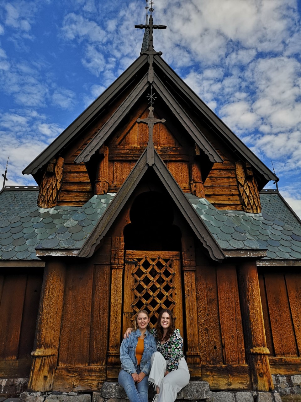 Gyda Elisa Sæter og venninne foran Hedalen stavkirke.