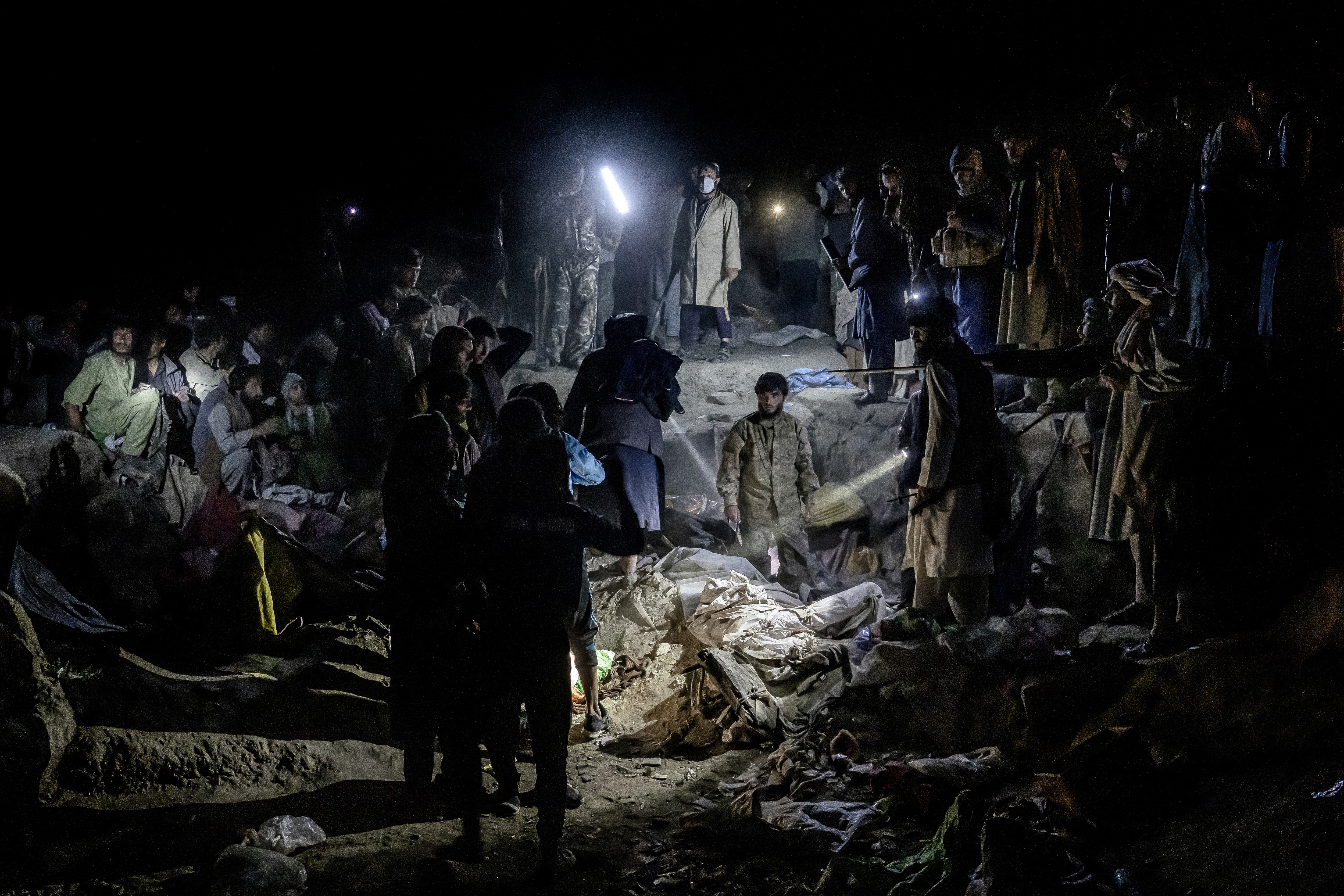 Taliban fighters look for drug addicts hiding in the garbage to detain and move them to a drug treatment camp, in Kabul, Afghanistan, Wednesday, June 1, 2022. Drug addiction has long been a problem in Afghanistan, the world’s biggest producer of opium and heroin. The ranks of the addicted have been fueled by persistent poverty and by decades of war that left few families unscarred. (AP Photo/Ebrahim Noroozi)