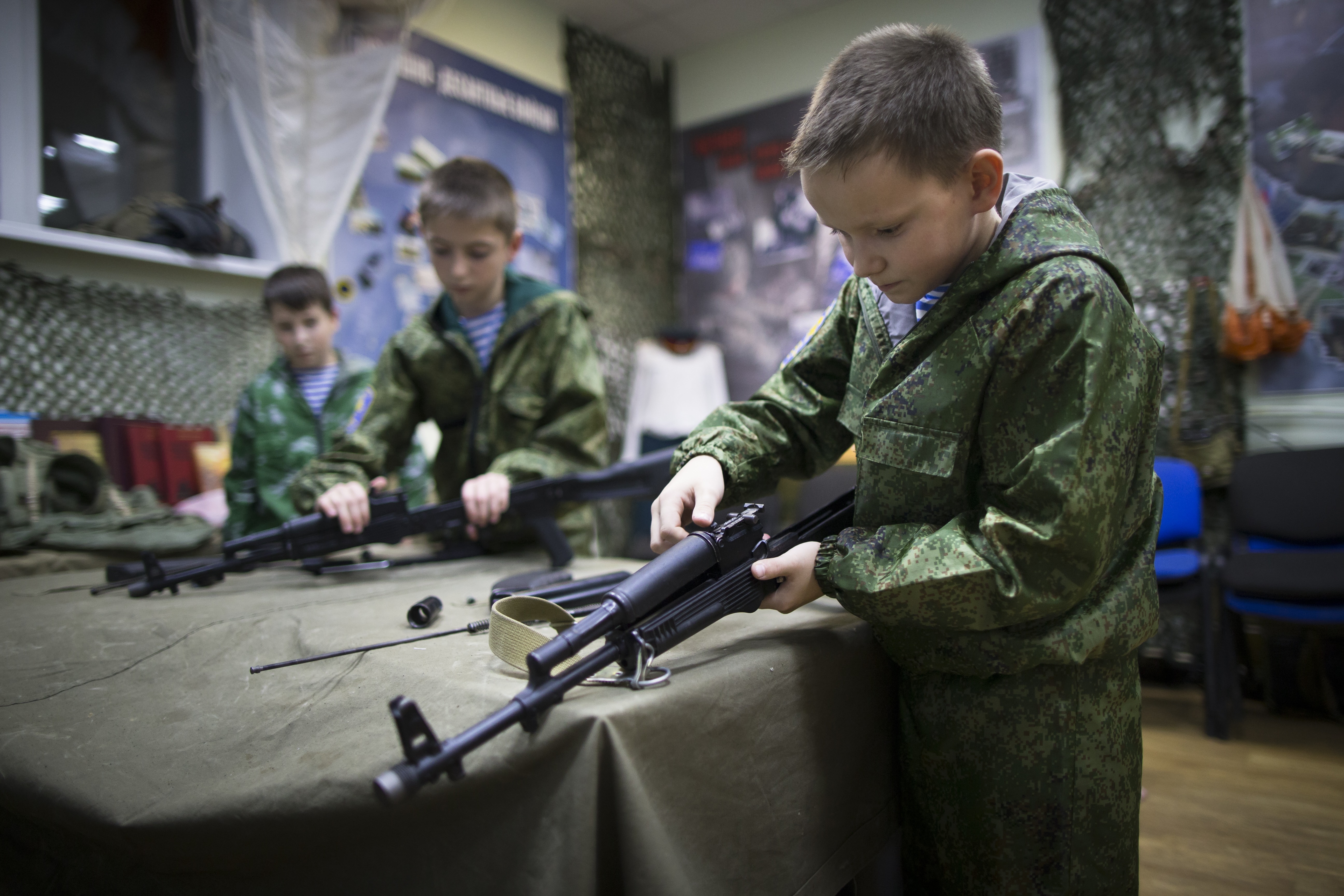 n this photo taken on Friday, Oct. 28, 2016, Alexander Yadryshnikov, 10, front, and his friends past apart Kalashnikov rifles as part of training in Verkhnyaya Pyshma, just outside Yekaterinburg, Russia. The training has been run by Yunarmia (Young Army), an organization sponsored by the Russian military that aims to encourage patriotism among the Russian youth. (AP Photo/Alexander Zemlianichenko)