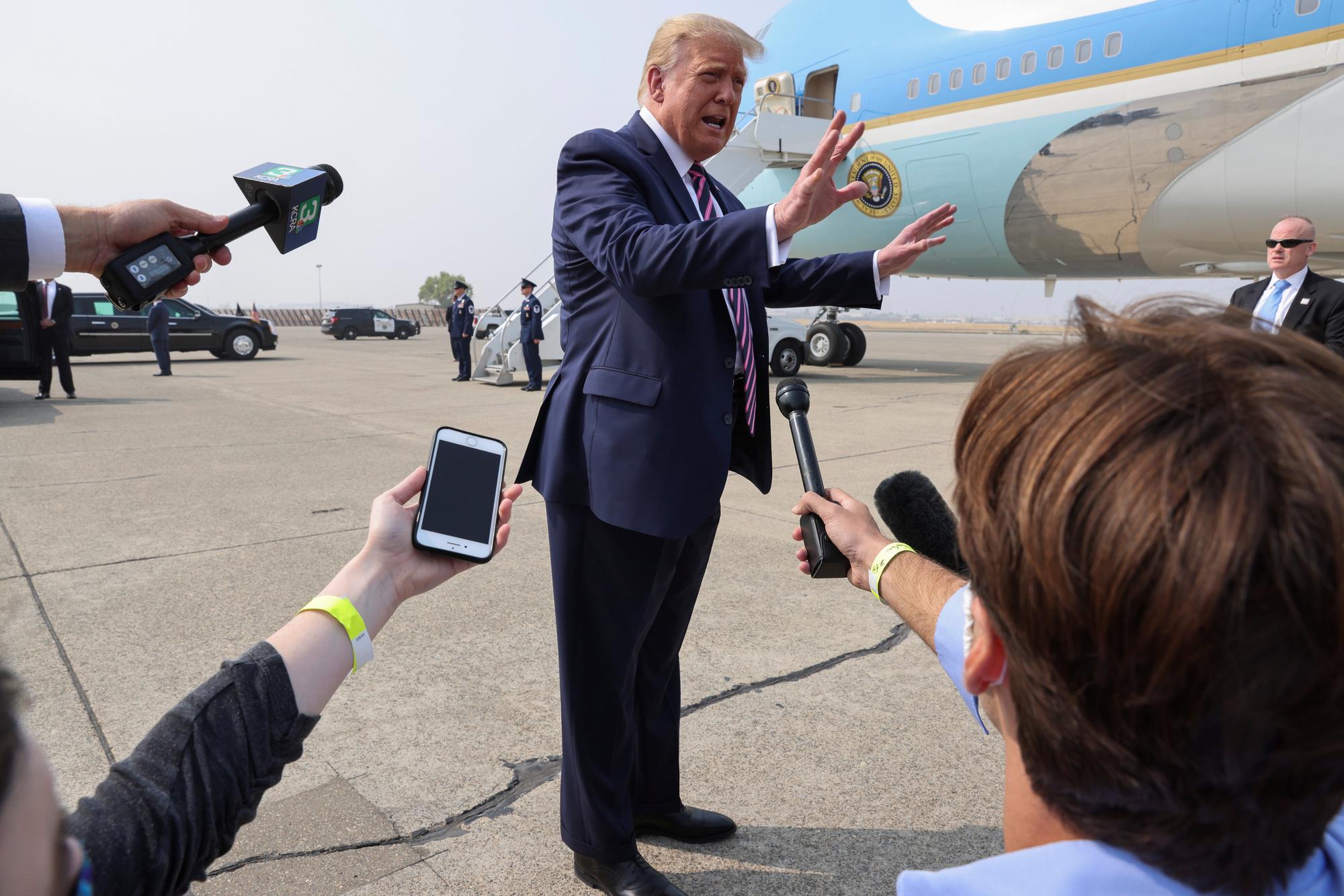 U.S. President Donald Trump talks with reporters in front of Air Force One as the president arrives for a briefing on the fires in California in McClellan Park, California, U.S., September 14, 2020. REUTERS/Jonathan Ernst