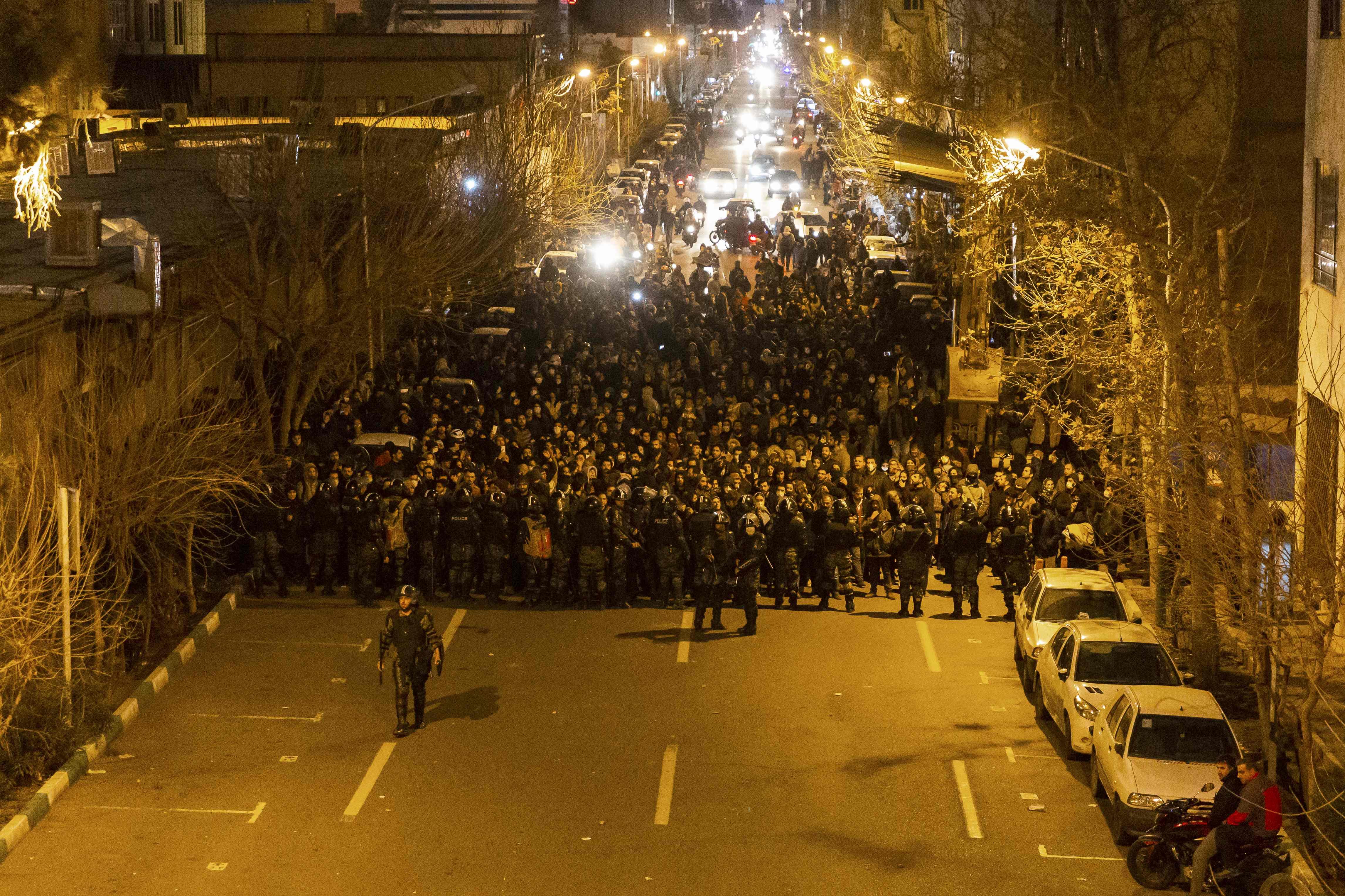 Iranian riot police stand guard as protesters gather in front of Tehran's Amir Kabir University on January 11, 2020. - Demonstrations broke out for a second night in a row after Iran admitted to having shot down a Ukrainian passenger jet by mistake on January 8, killing all 176 people on board. (Photo by STR / AFP)