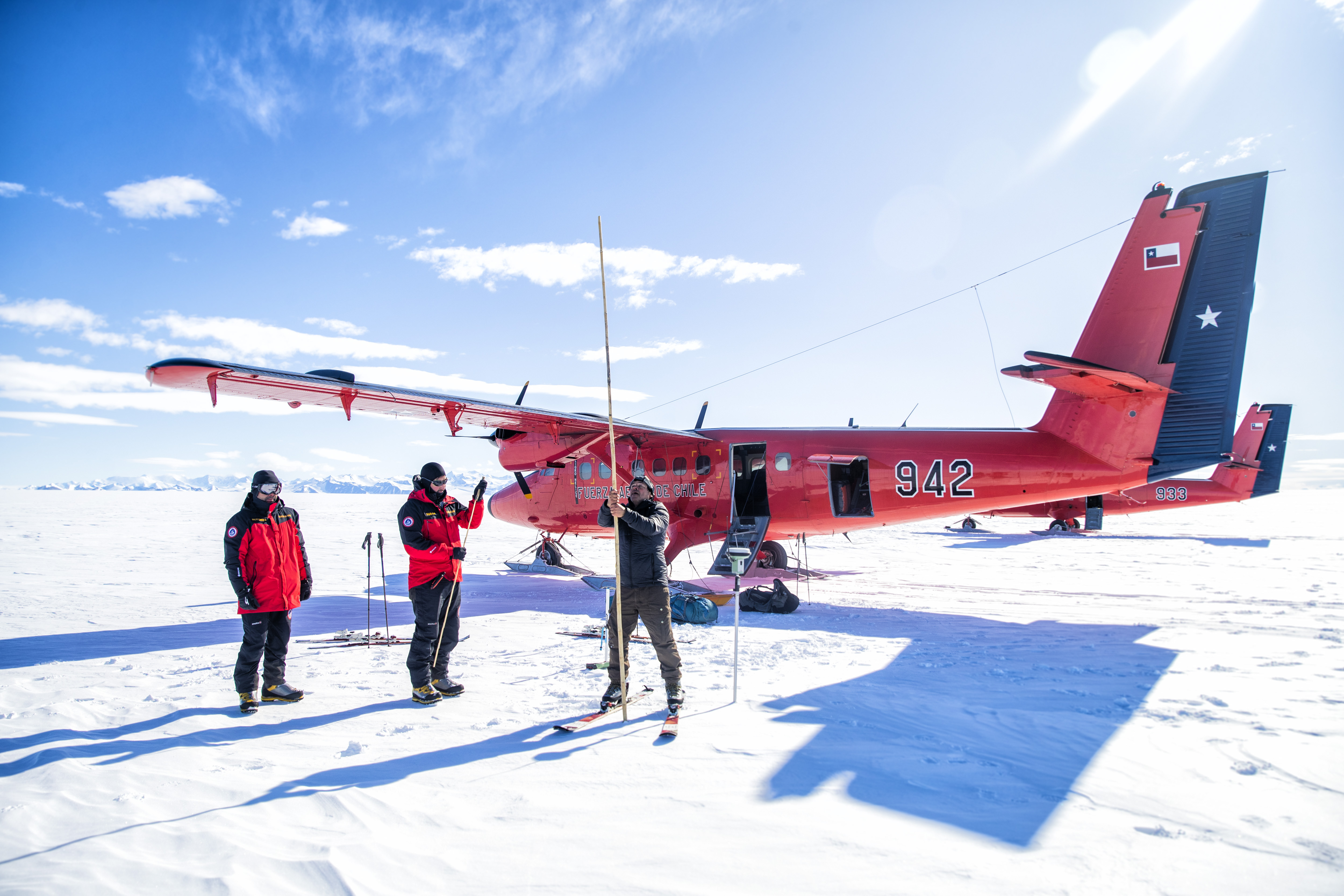 El glaciólogo Ricardo Jaña clava una vara de bambú en la mayor plataforma de hielo del mundo, la de Filchner-Ronne, escoltado por los exploradores militares 'Inmortal' y 'Prometeo'.