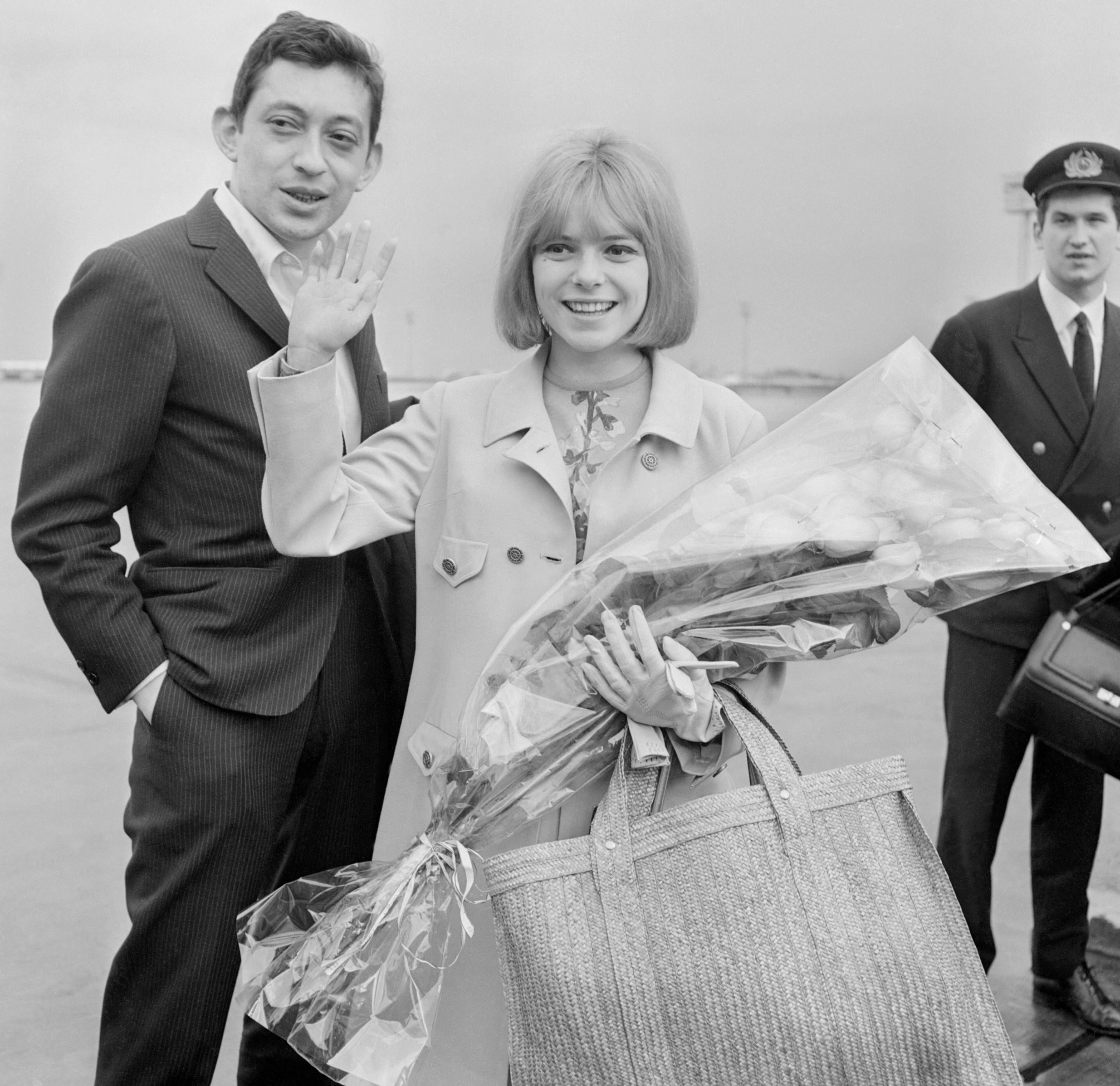 (FILES) In this file photo taken on March 21, 1965 French singer France Gall waves to fans next to singer-songwriter Serge Gainsbourg, upon her arrival at Orly airport a day after she won the 1965 Eurovision Song contest with 