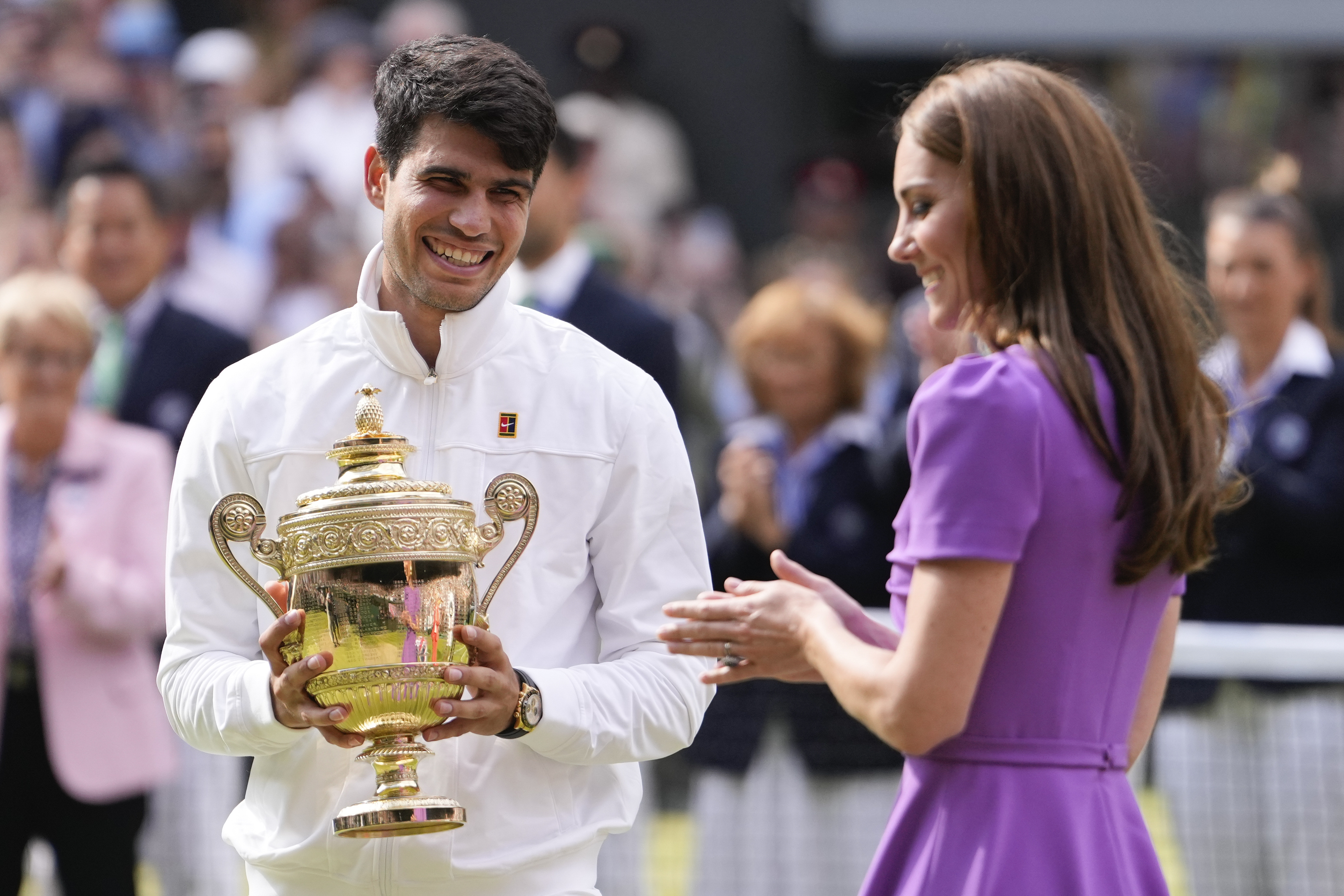 Carlos Alcaraz of Spain reacts after receiving his trophy from Kate, Princess of Wales after defeating Novak Djokovic of Serbia in the men's singles final at the Wimbledon tennis championships in London, Sunday, July 14, 2024. (AP Photo/Alberto Pezzali)